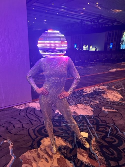 Performer in a white costume and the LED helmet lit up with a logo for a corporate event in Charleston, South Carolina
