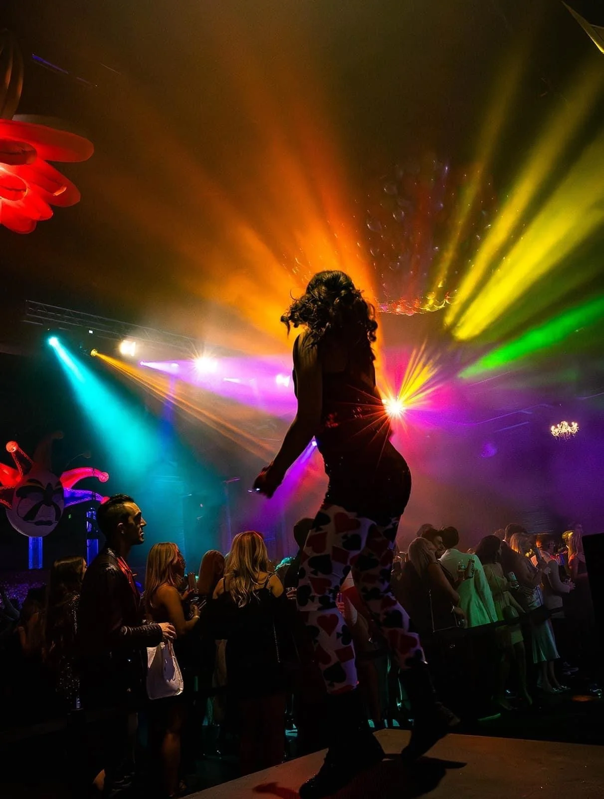 Go-Go Dancer in Playing Card Leggings Surrounded by Laser Lights in Charleston
