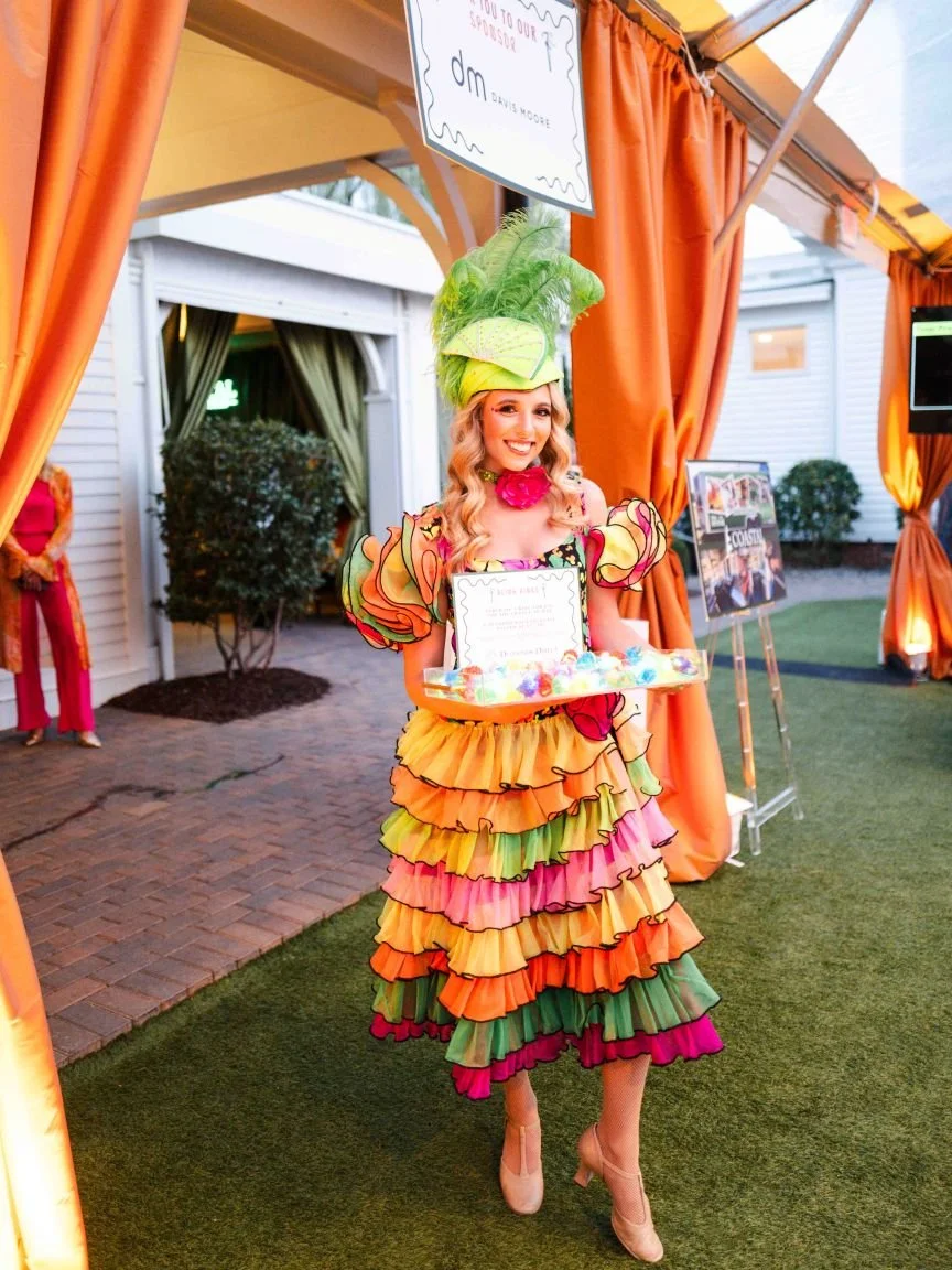 Copa Girl in Green, Yellow, Orange, and Pink Costume Handing Out LED Rings at Fundraiser