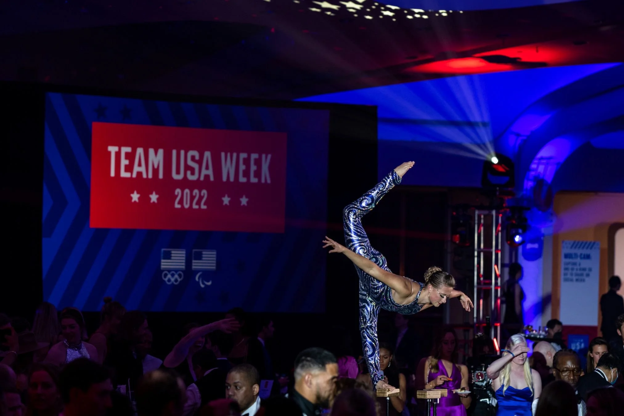 Contortionist in Standing Split on Canes in Blue and Silver Costume at Team USA Event in Washington DC
