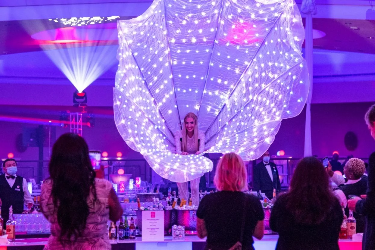 LED Peacock Performer Framing Face with Tail at Olympic Event