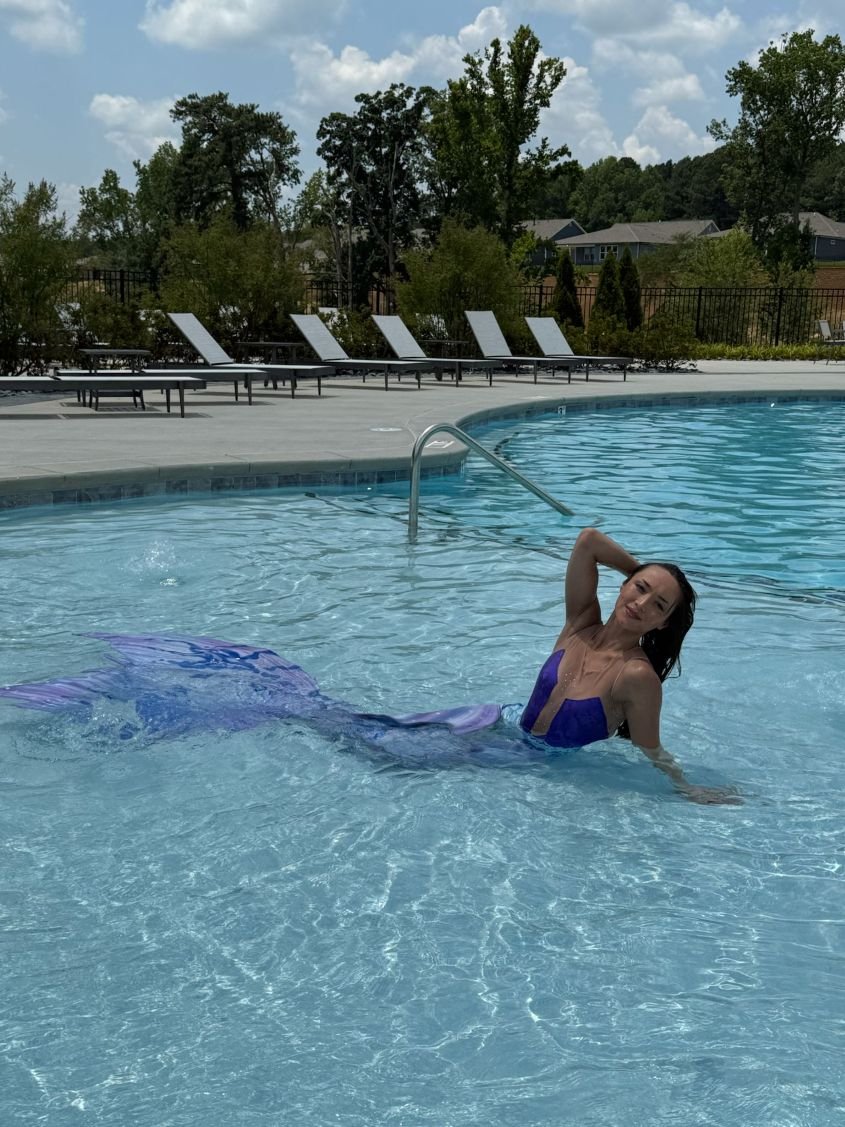 Purple Mermaid Reclining in Pool