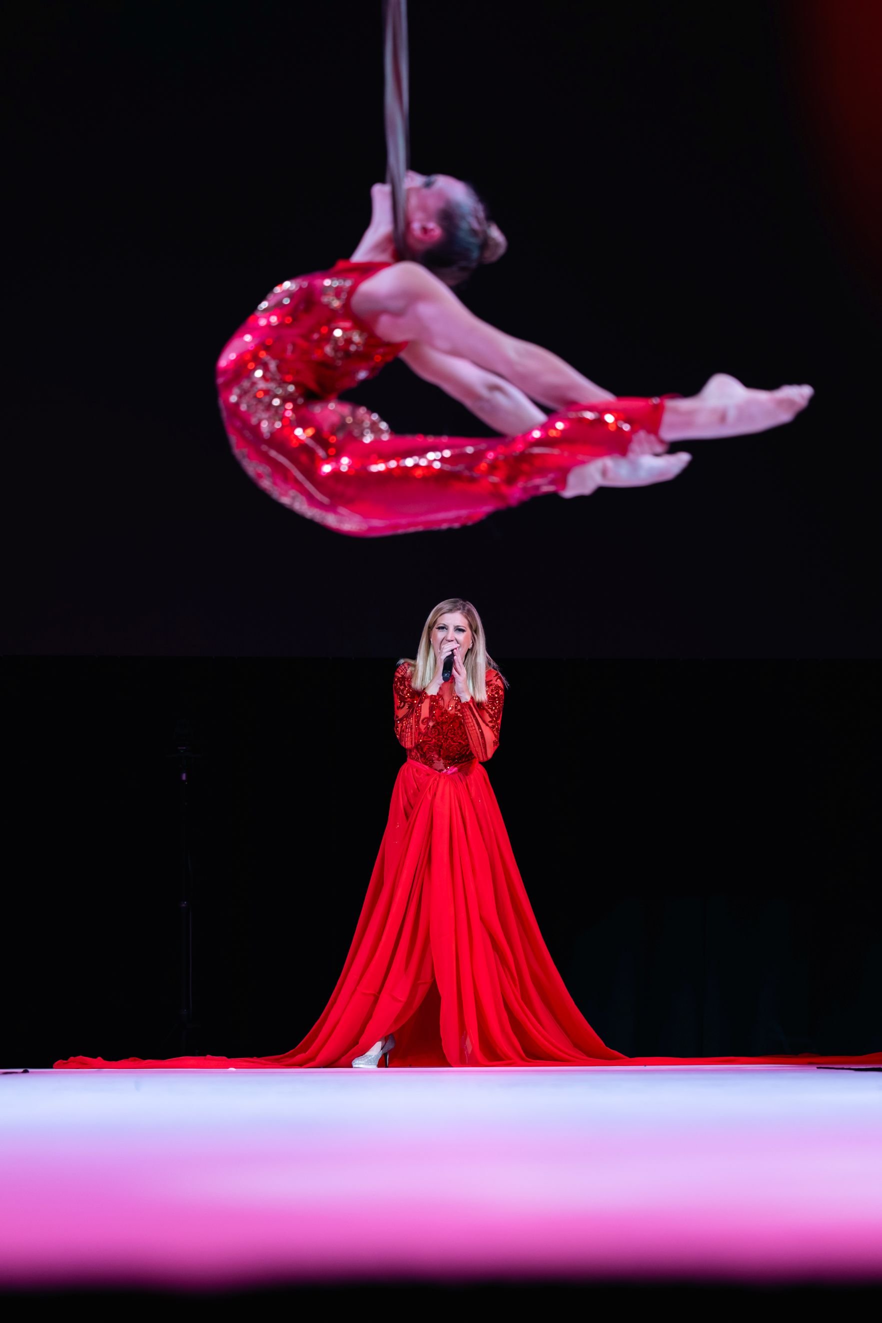 Aerialist and Vocalist in Dramatic Red Performance