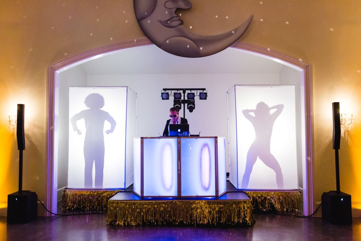 Two Black and White Shadow Dancers Flanking DJ