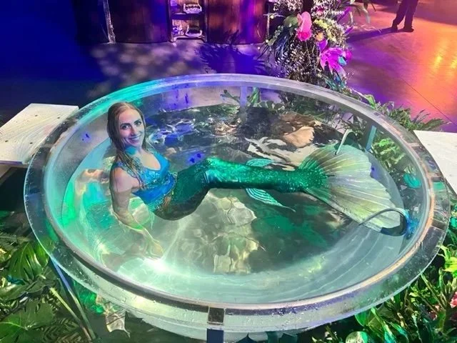 Mermaid Performer in Water Bowl Smiling Upward