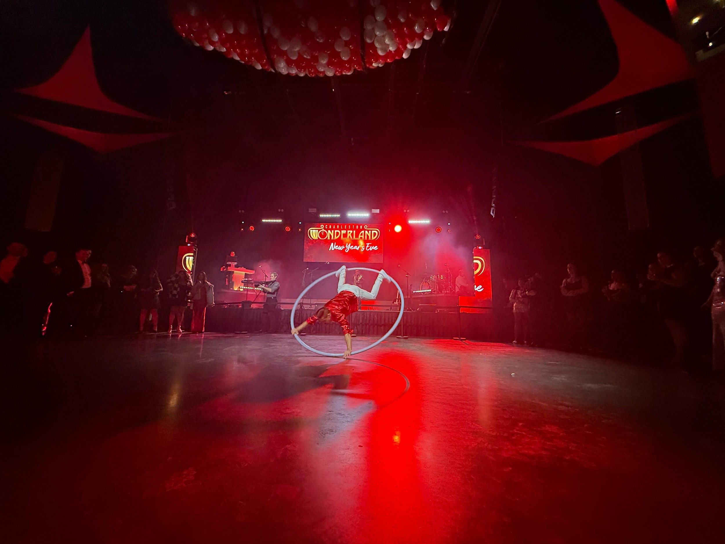 Interactive Cyr Wheel Performance at Red Themed New Years Eve Event in Charleston, SC