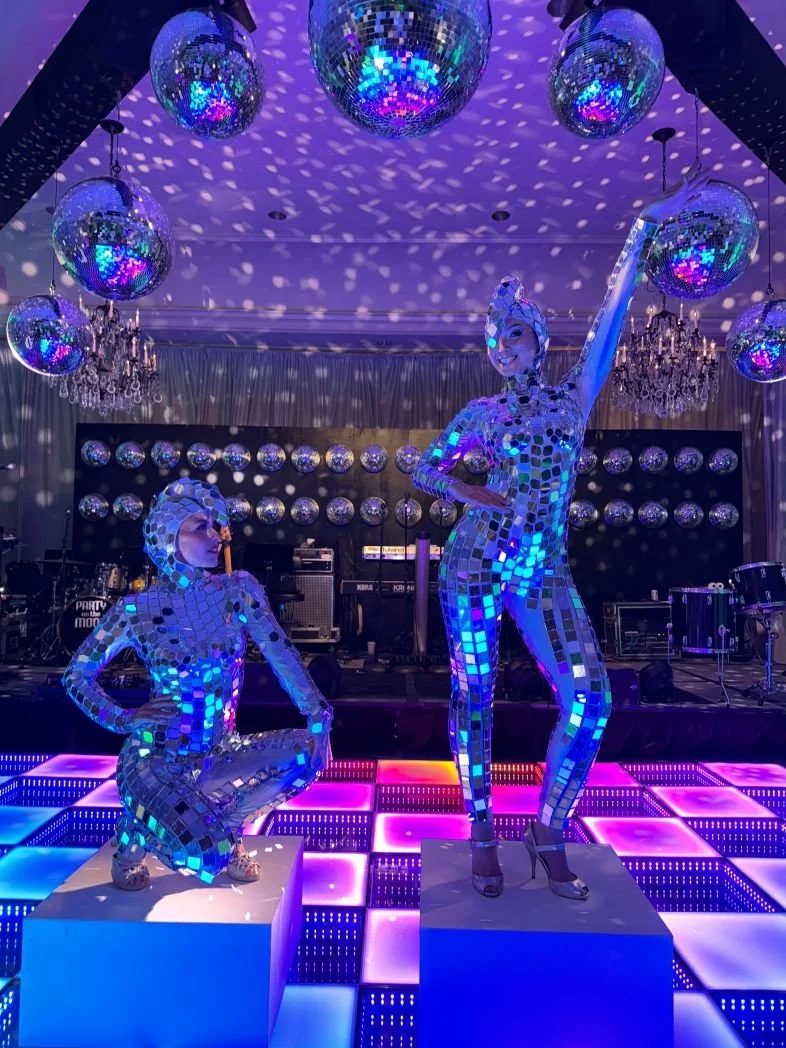 Mirror Girls Posing at a Studio 64 Themed Event