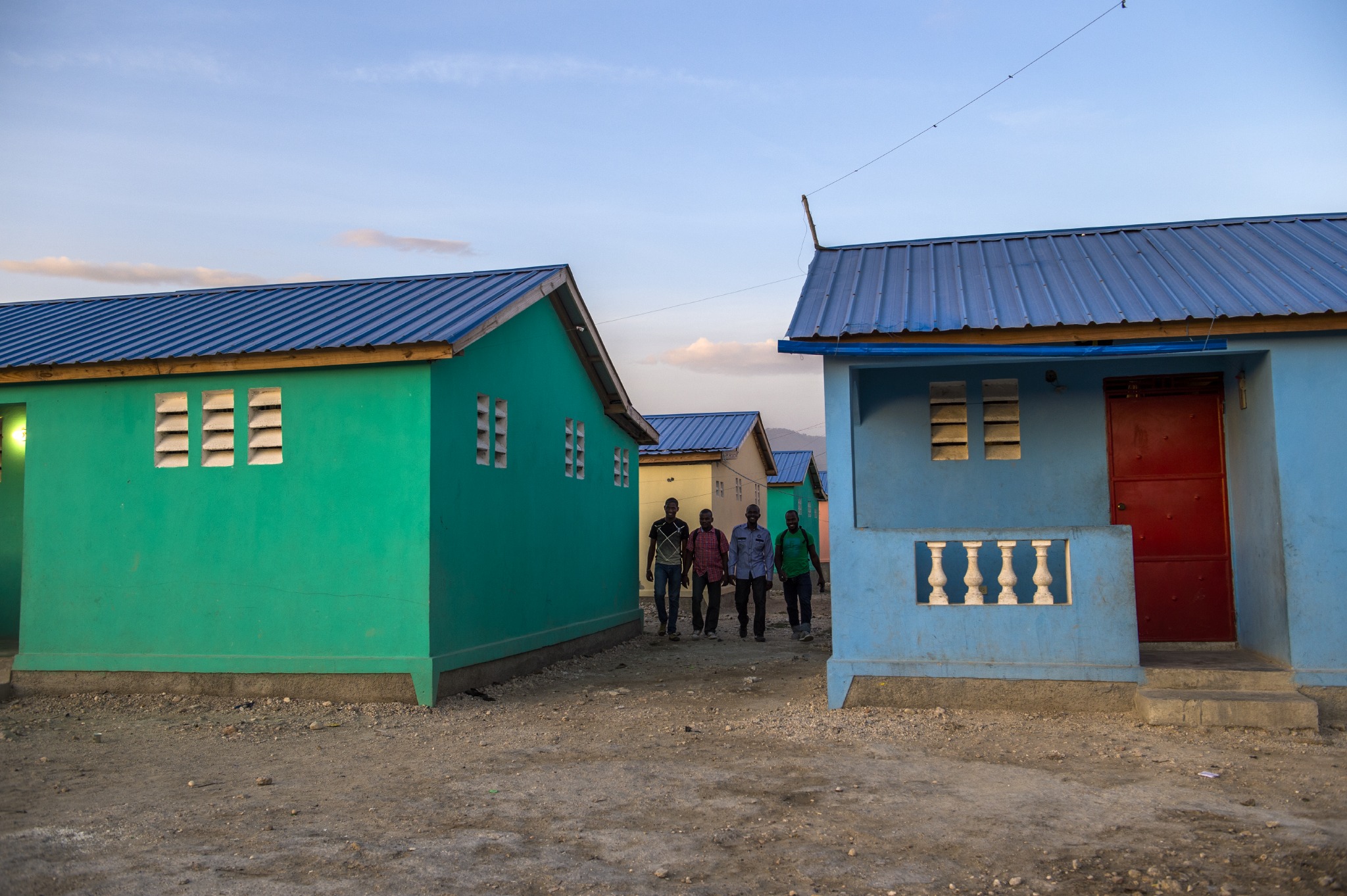 Members of our Haitian team stroll through houses built by the foundation in Port-au-Prince