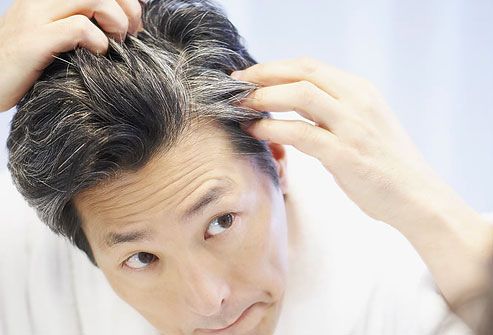photolibrary_rf_photo_of_man_looking_at_gray_hair.jpg