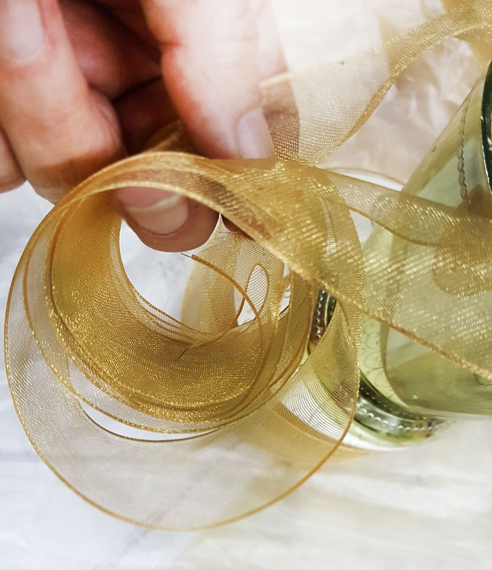 To keep the ribbon clean and tidy while creating your lovely designs, simply roll the ribbon in a loose loop and secure to the foam with half of a florist wire. This will keep the ribbon up out of any water that may overflow onto the work surface as you insert the lovely blossoms.