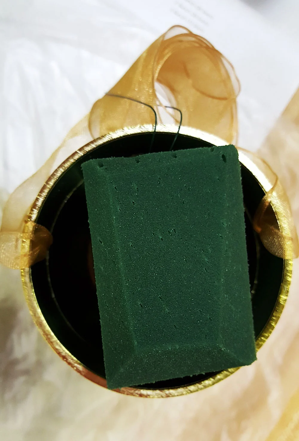 Be sure to measure your foam, leaving space on either side to allow room for the ribbon. We prefer to use sheer nylon ribbons as they are much more forgiving of water. Nylons repel water and do not wick the water from the design foam as satin or cotton fabric will. Just be mindful of your ribbon and no staining will occur.