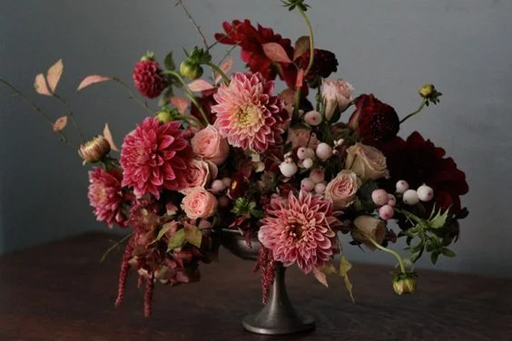 A small compote filled with the richest colors and textures. Amaranthus drips down the sides of this summer arrangement that looks good enough to eat.