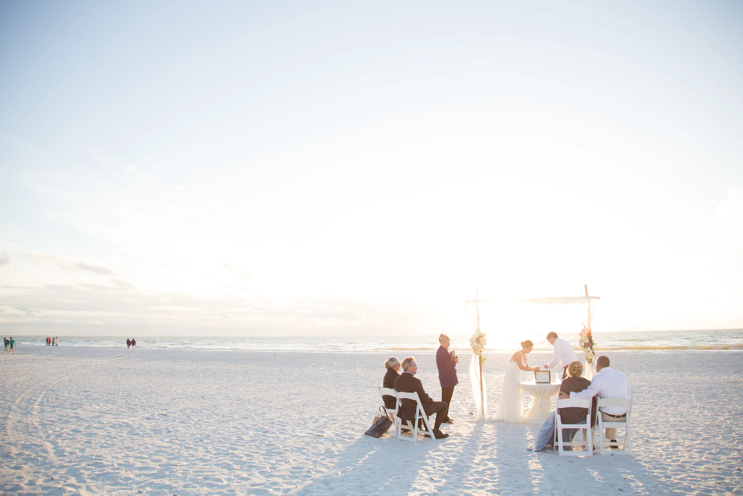 Beautiful, sunny, and intimate Florida beach wedding at Sunset. Documentary Wedding photographer for the genuine couple in love.