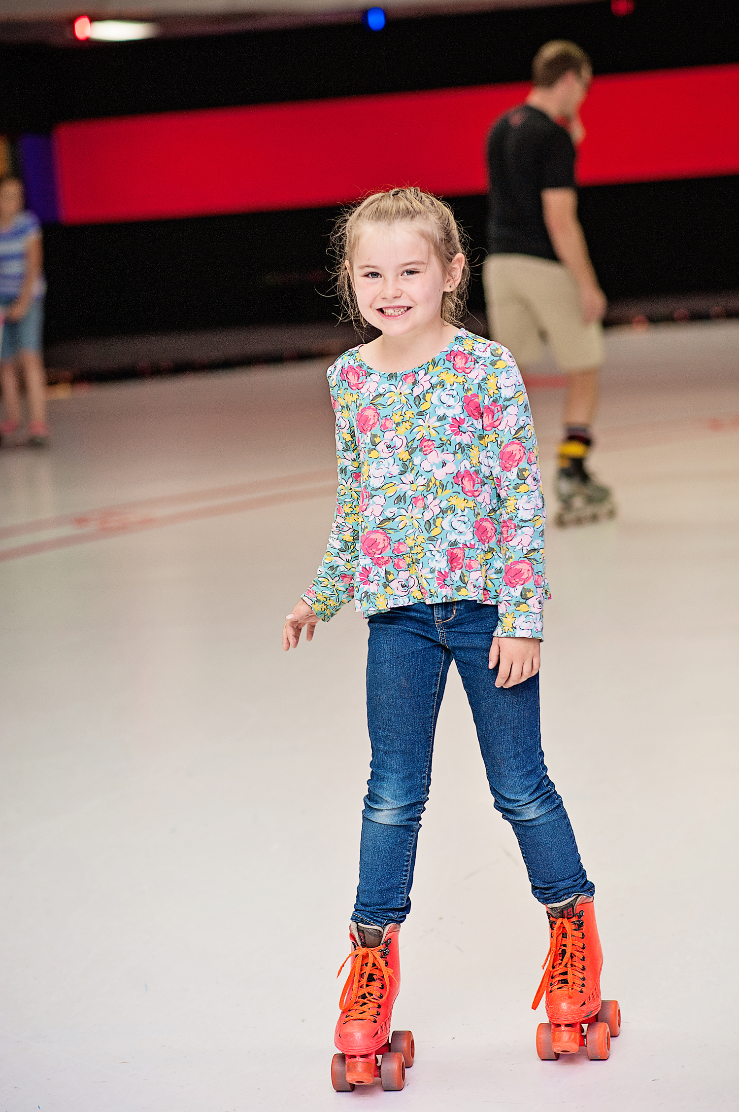  Girl skates on rink cote skating floor at classic fun center 