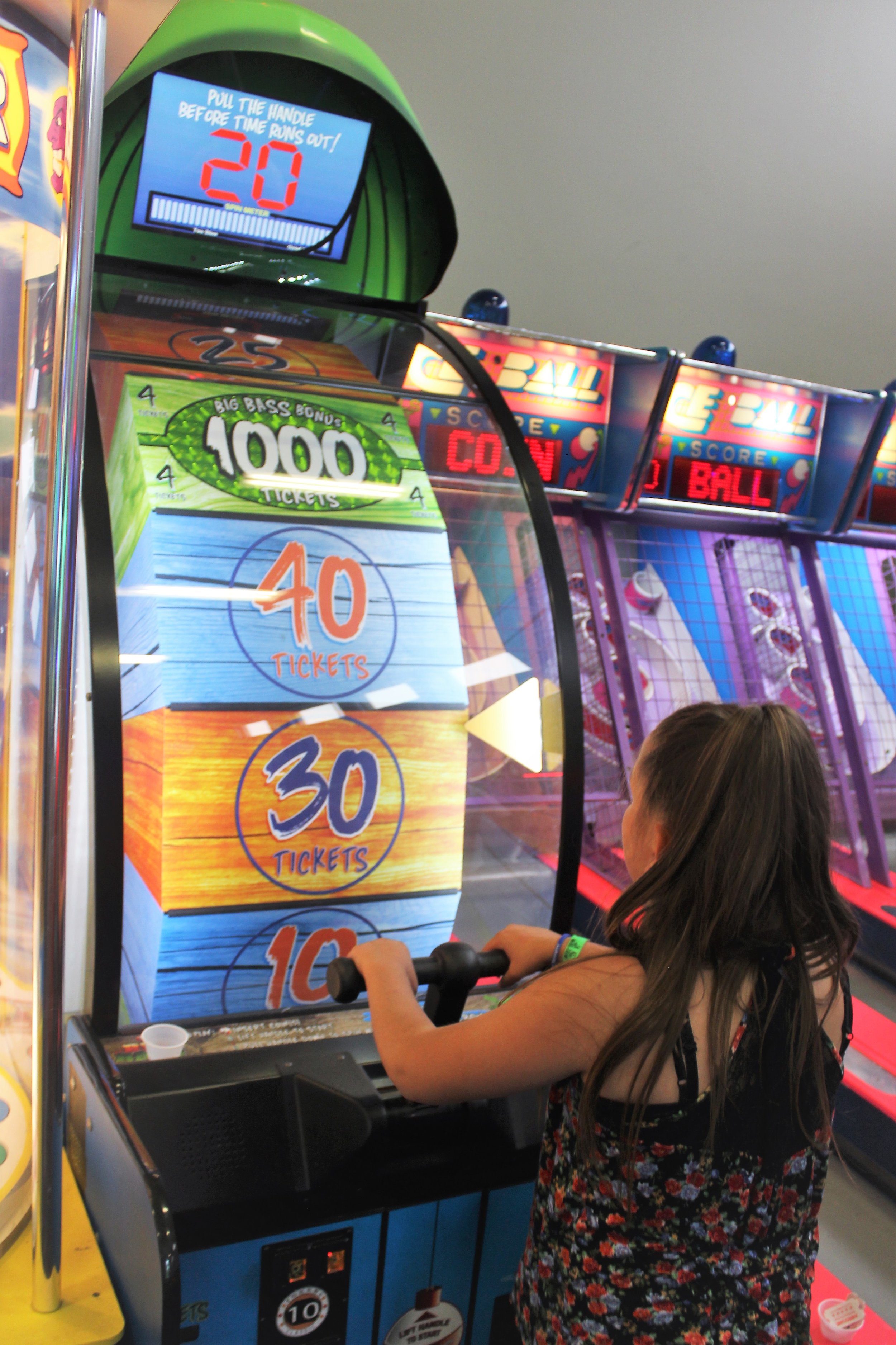  big bass wheel arcade game being played in classic fun center  