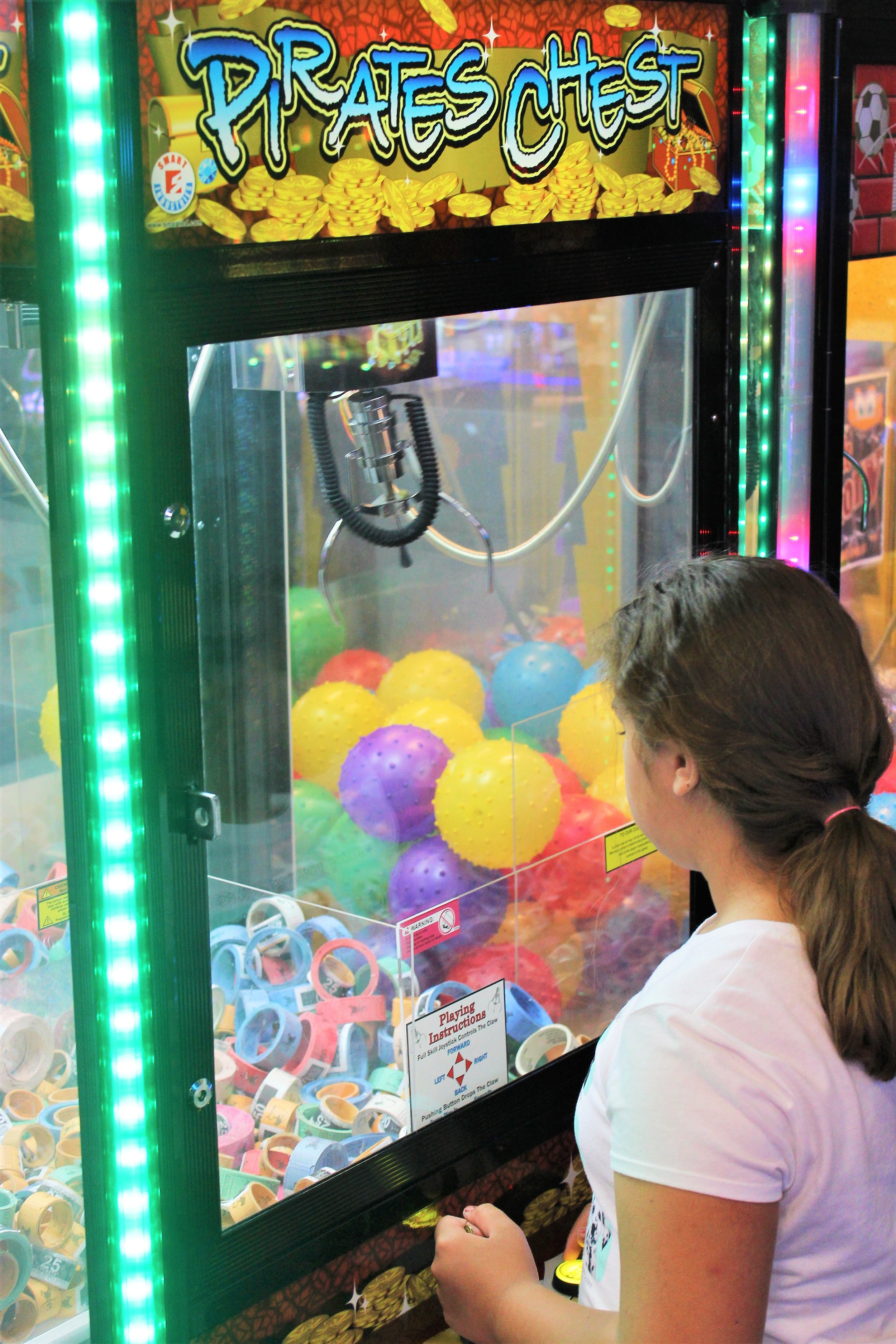  Girl enjoying a ticket claw arcade game 