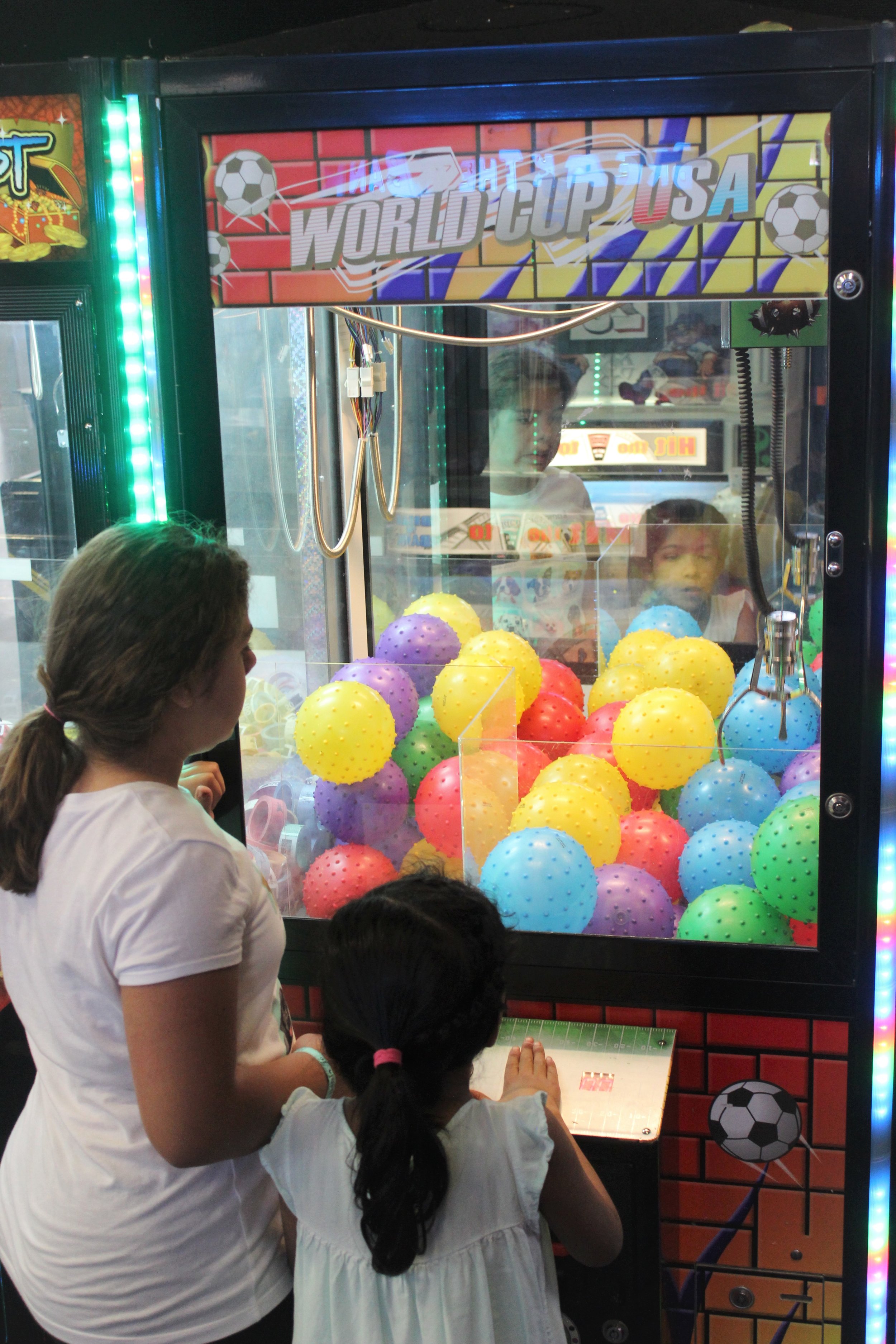  two sisters enjoying family fun in an arcade 