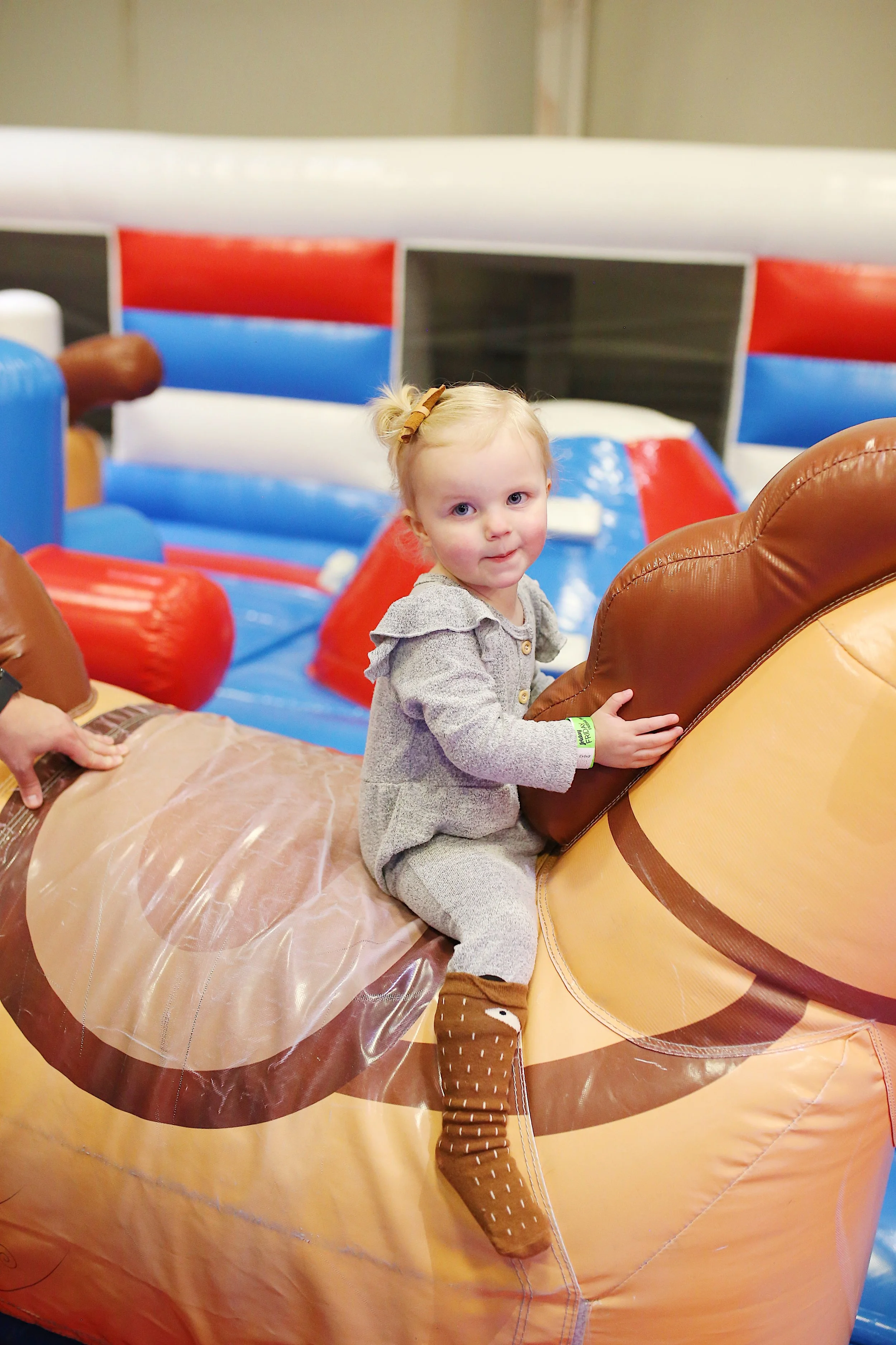  toddler enjoys riding inflatable horse 