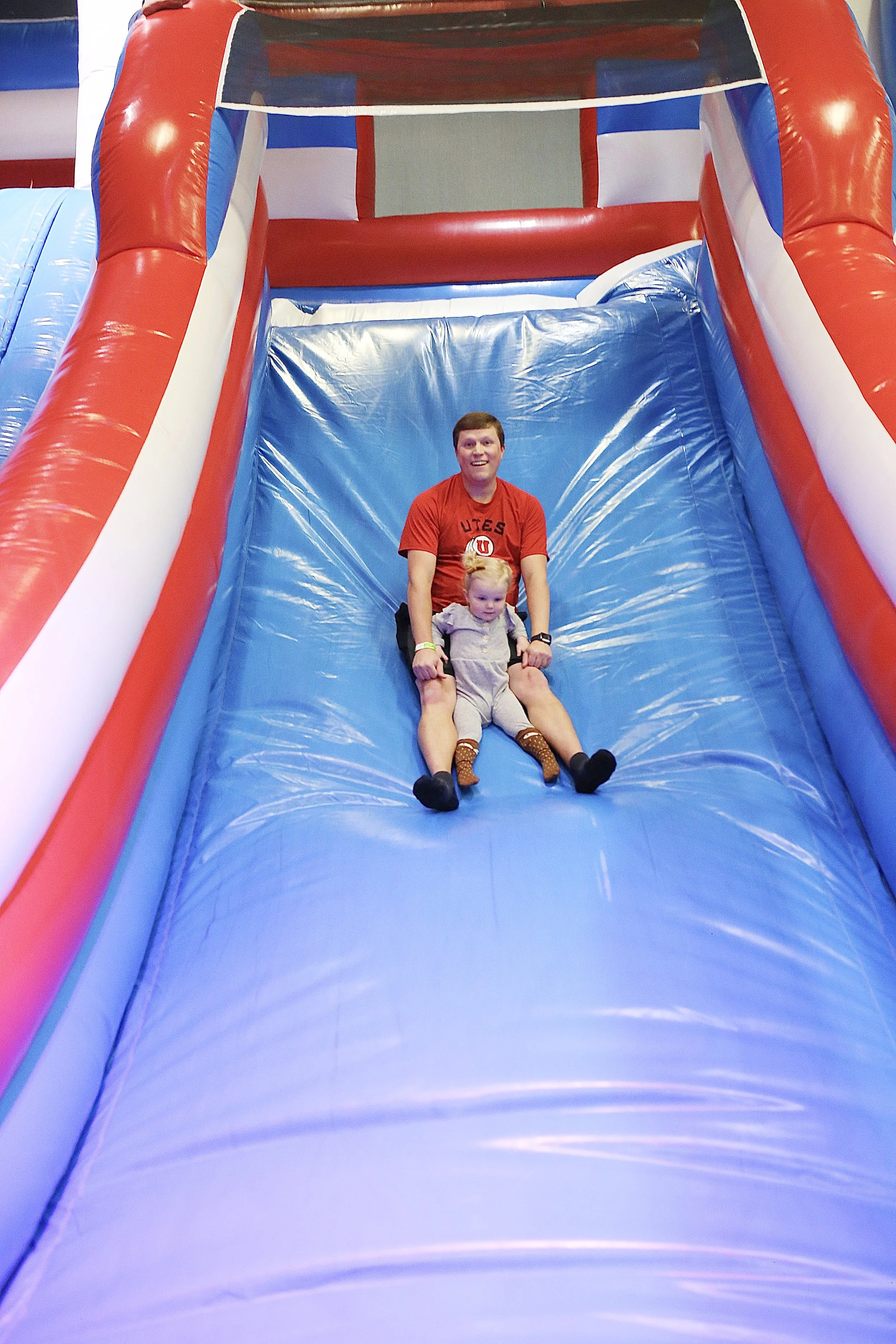  father and daughter enjoying family entertainment at classic fun center bouncy houses  
