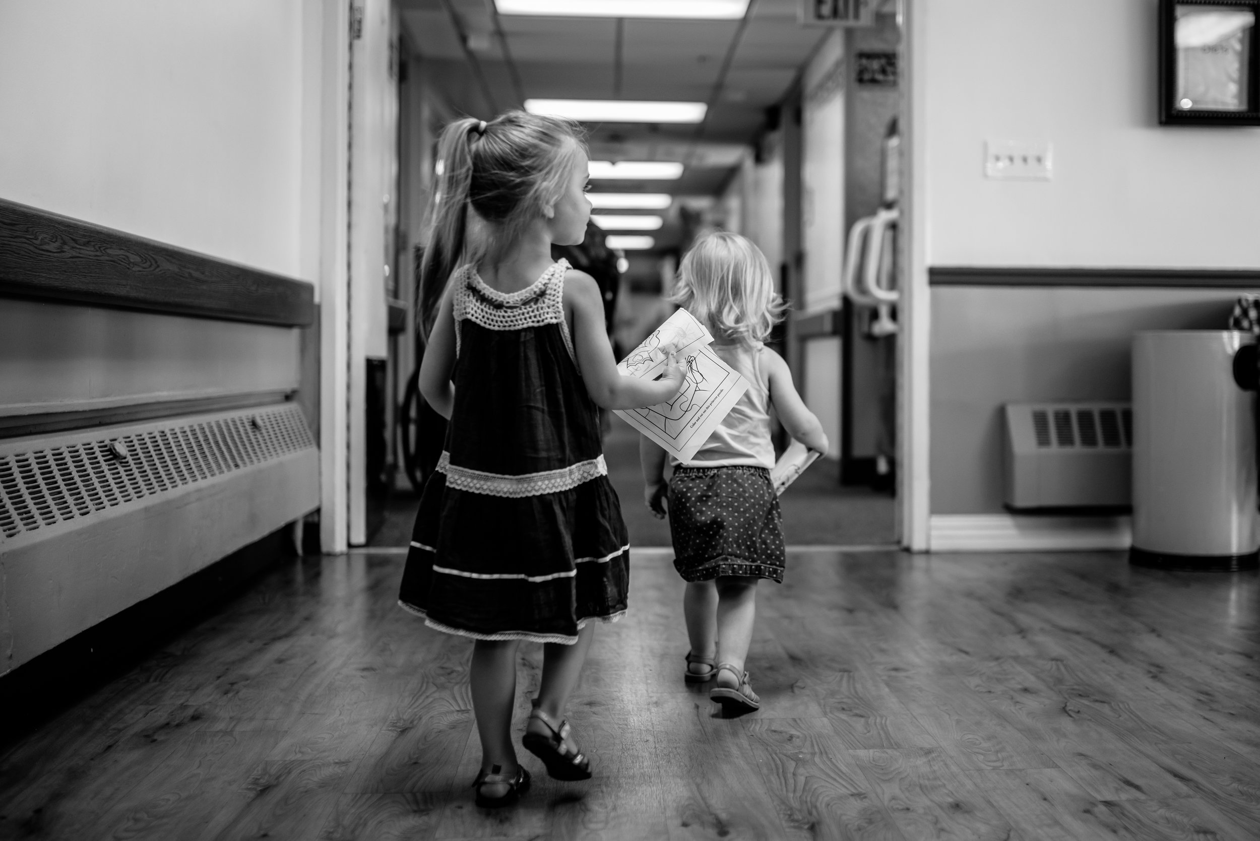 Girls walking down hallway of nursing home