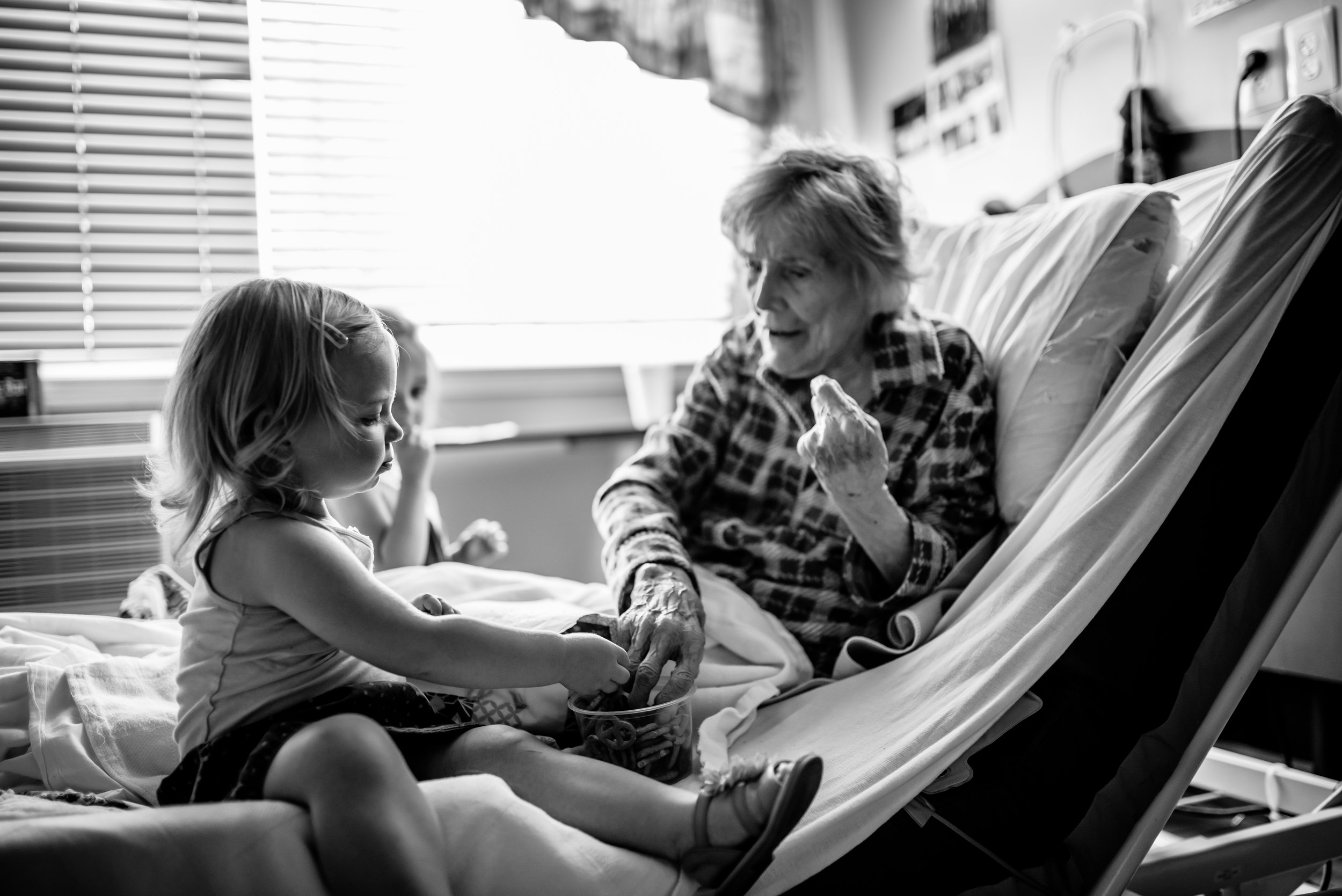 Girls share pretzels with great-great-grandmother