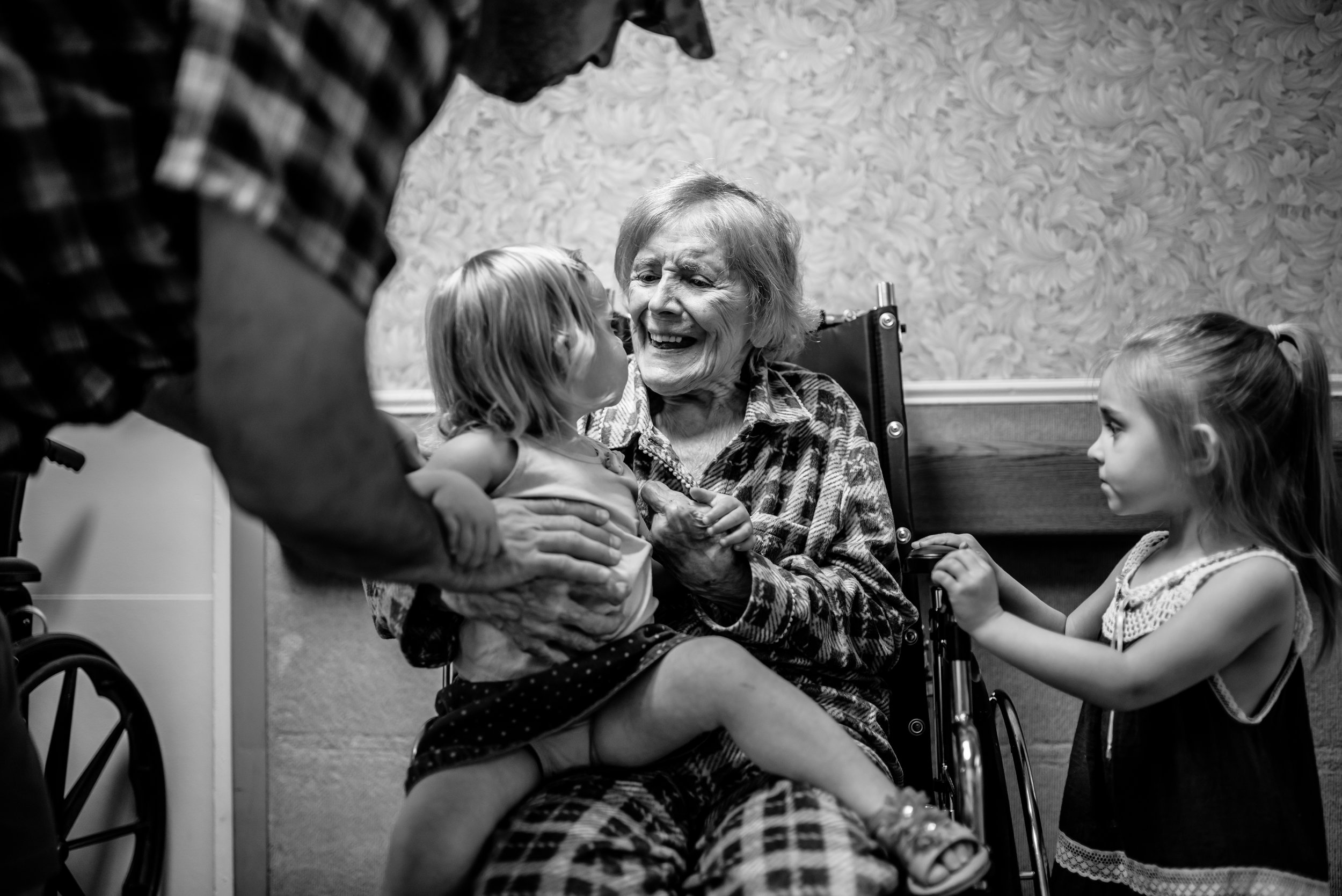 girl sits on great-great-grandmother's lap