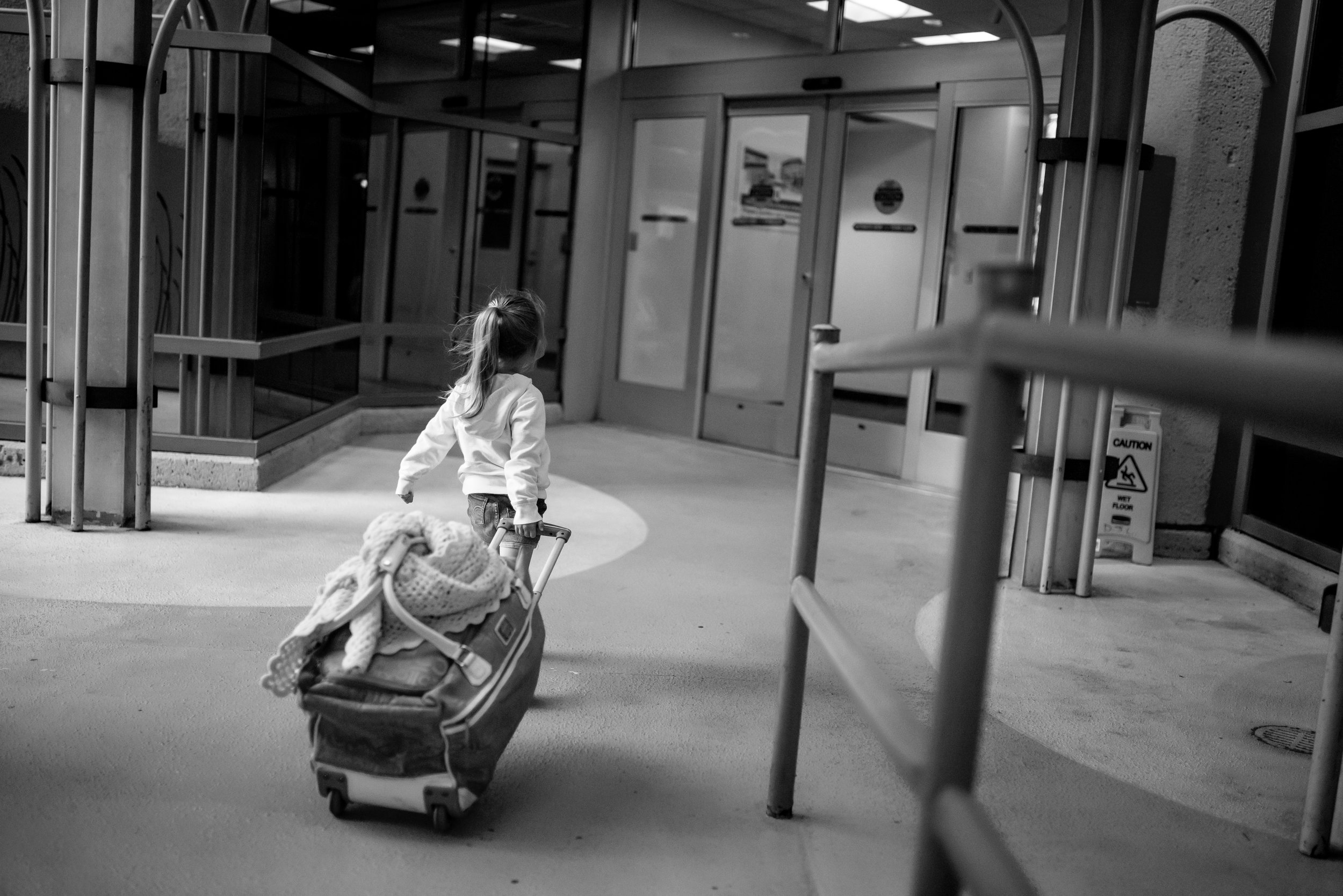 Girl with suitcase enters hospital for heart procedure