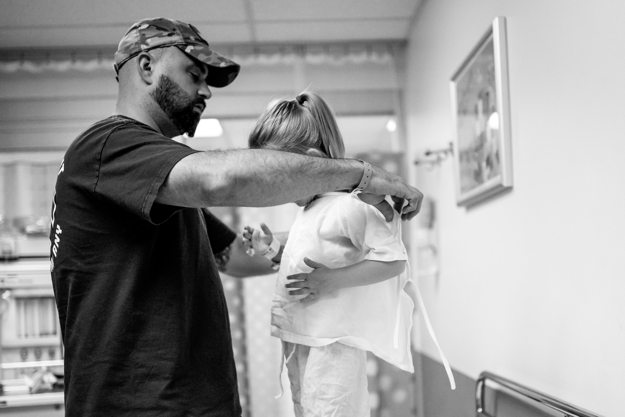 Dad changes girl hospital gown surgery prep children's hospital