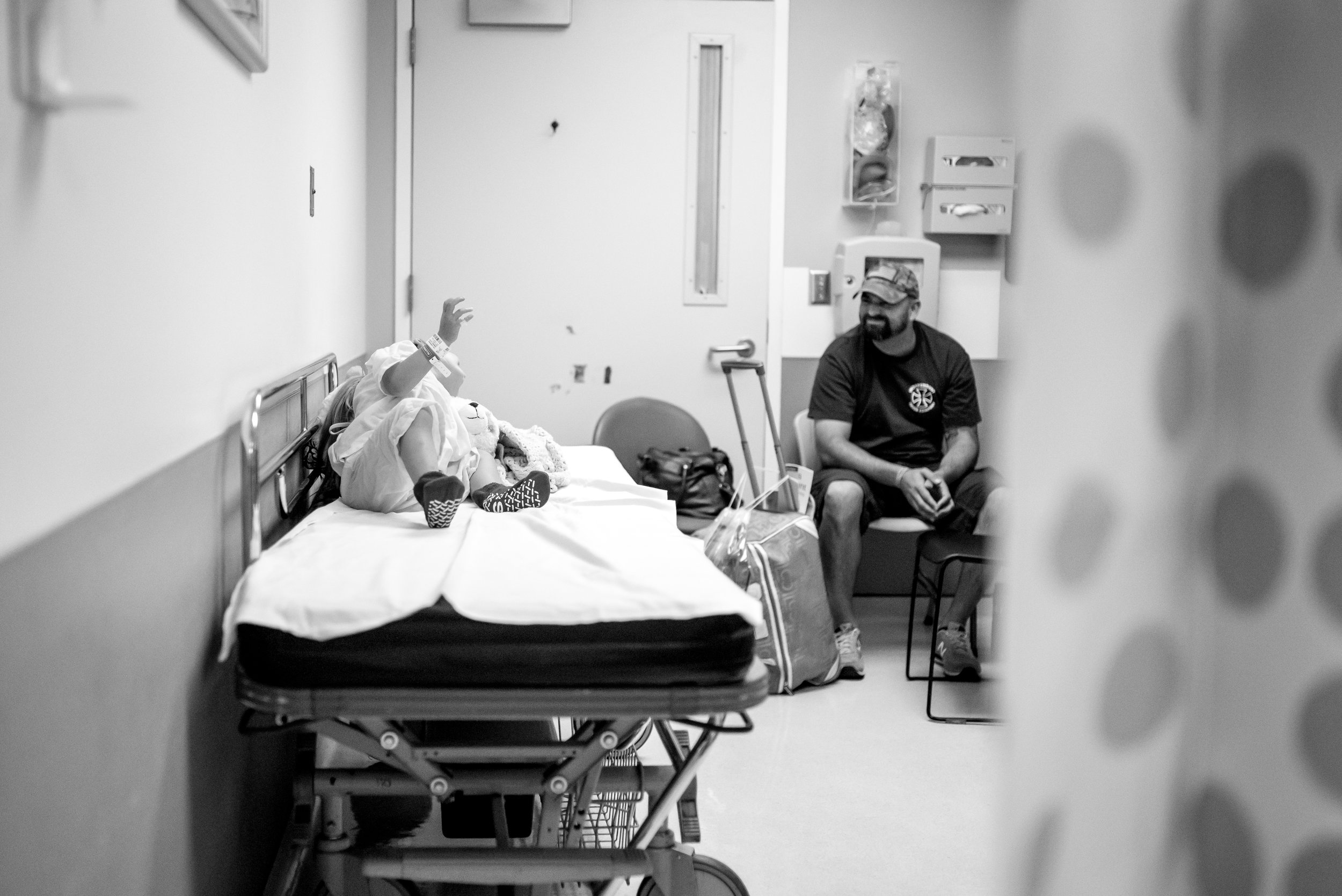 Dad and daughter wait in surgery prep at children's hospital