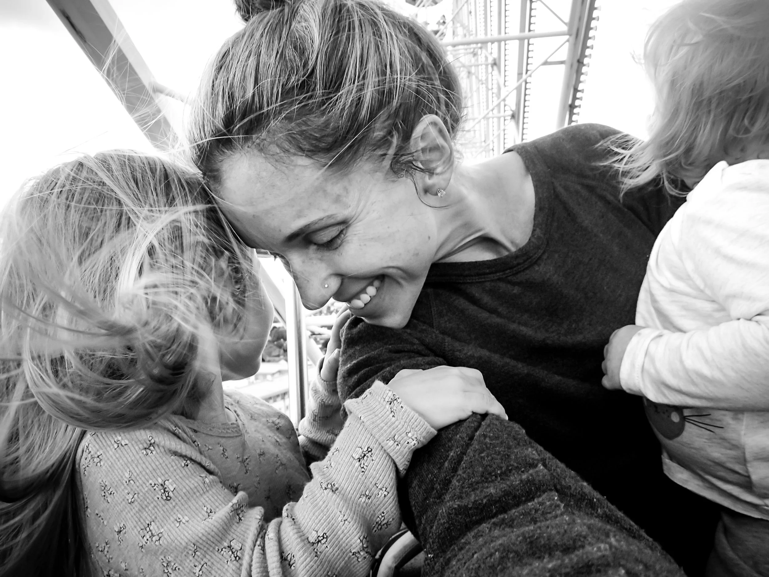 Mom with daughters on ferris wheel smiling