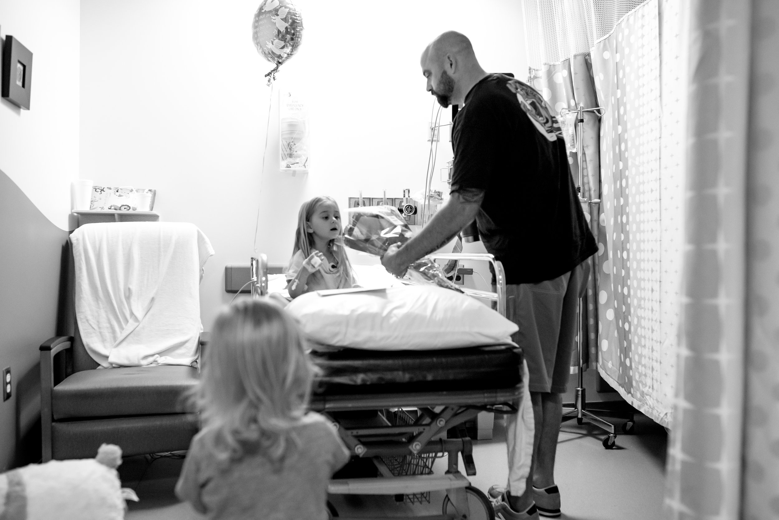 Dad presents flowers to daughter in hospital