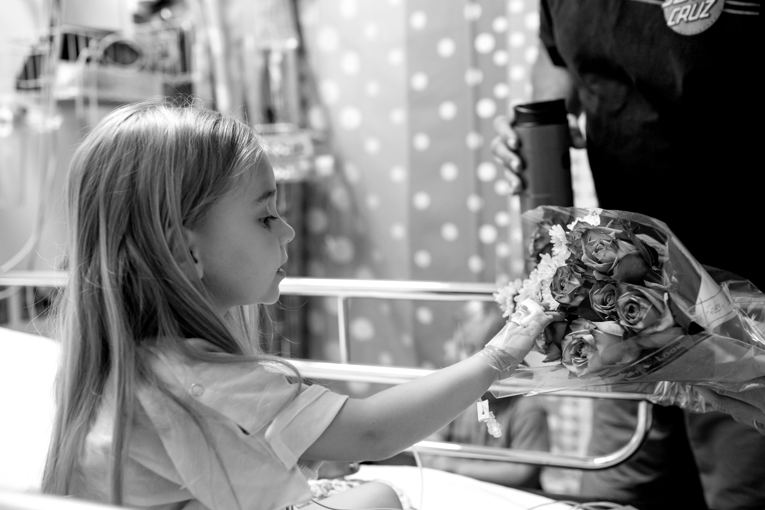 Girl touches flowers in hospital