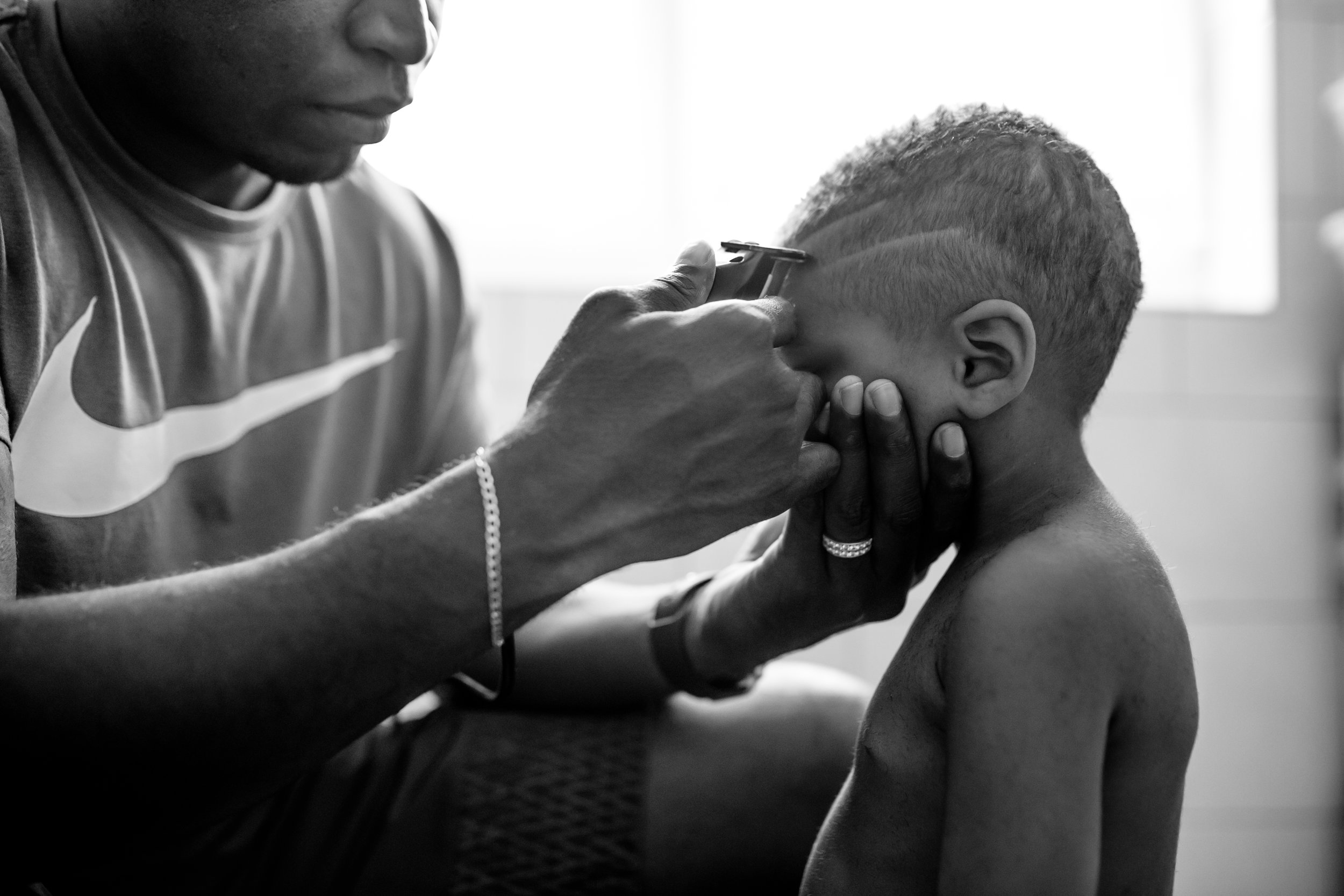 Dad cuts design into son's hairstyle