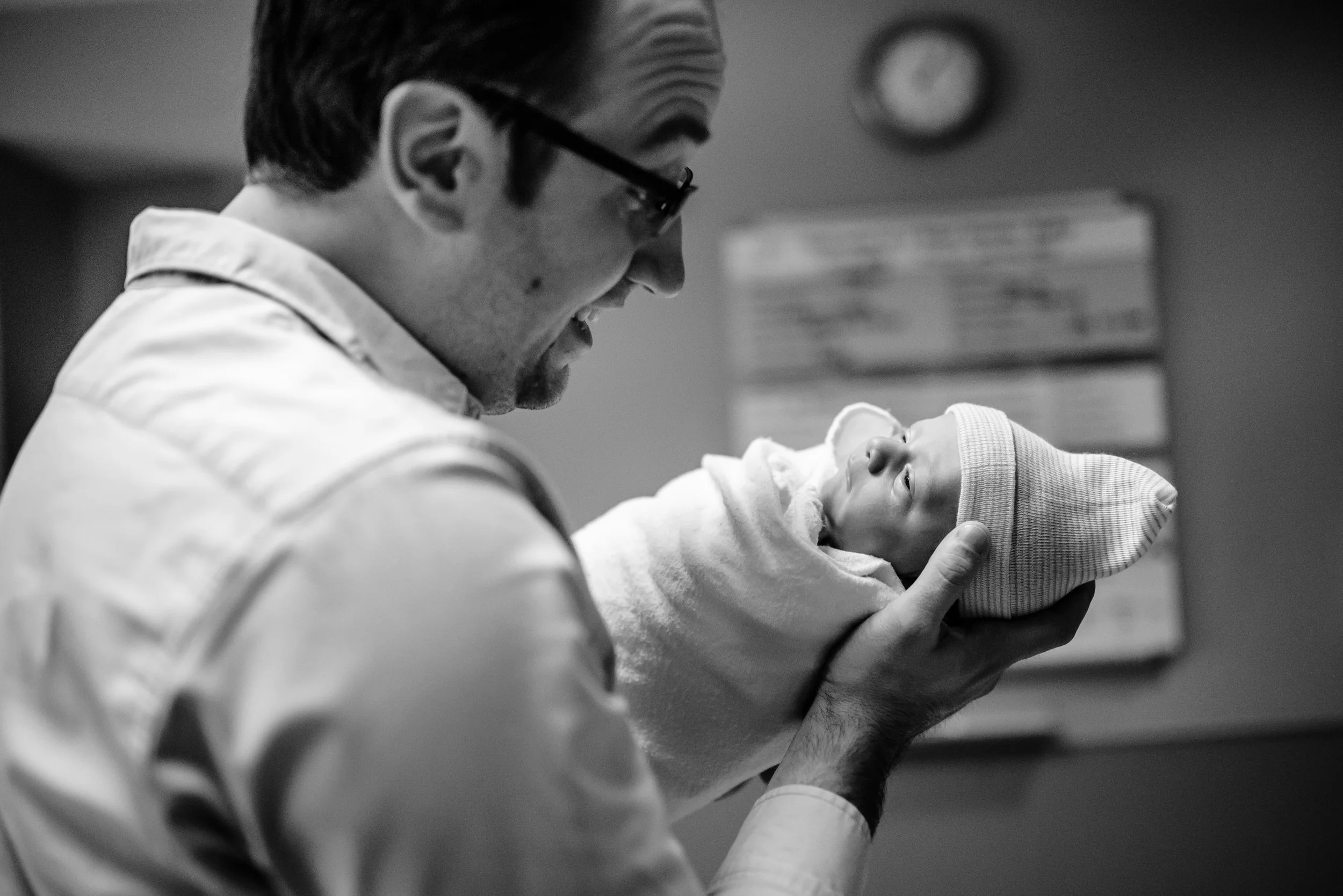 Dad holds newborn in hospital