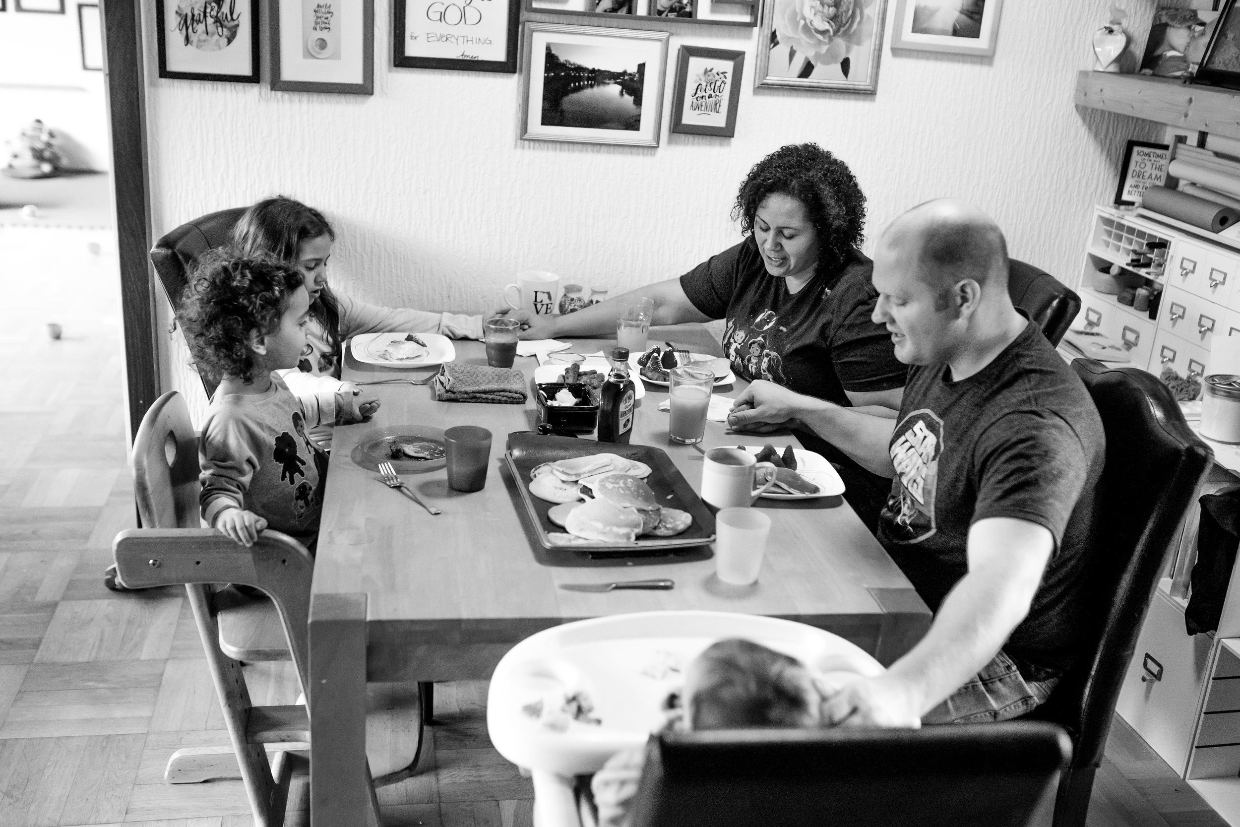 Family prays at table before meal