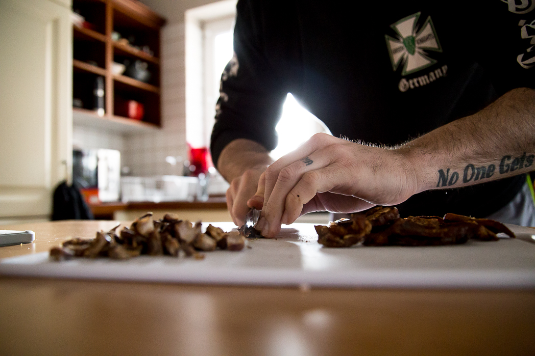 Man cuts meat on cutting board