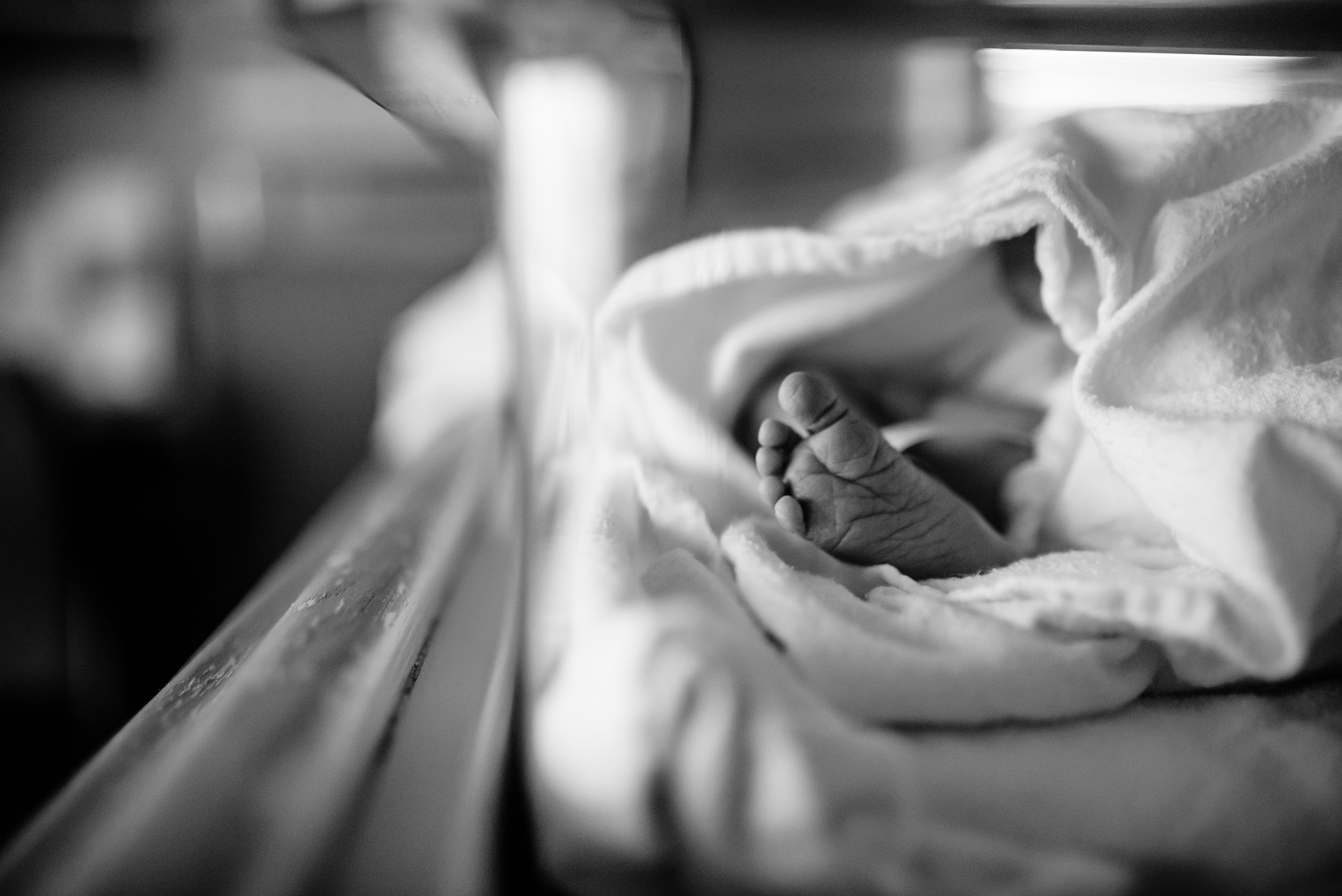 Newborn's foot peaking out of blanket