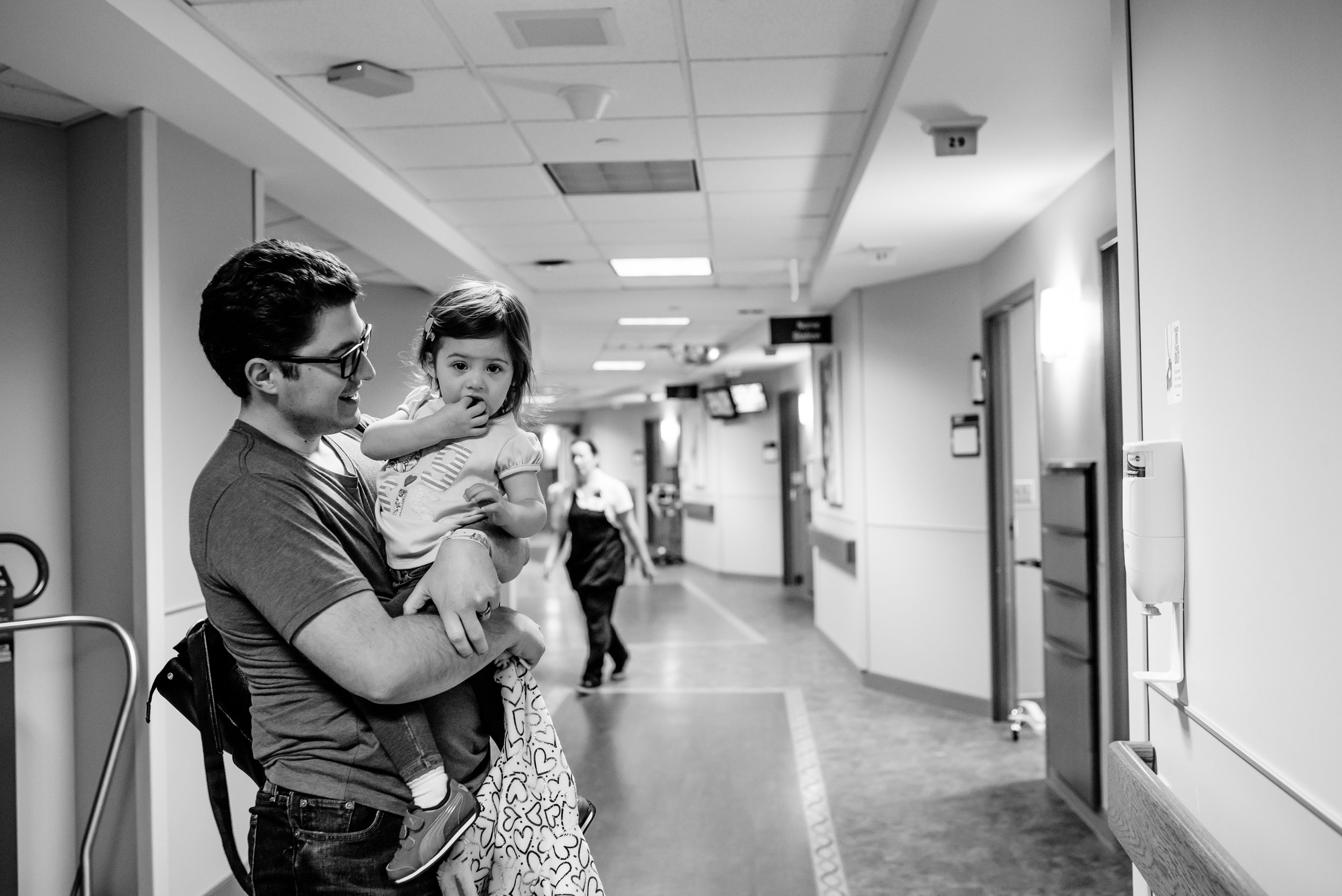 Dad holds daughter in hospital hallway