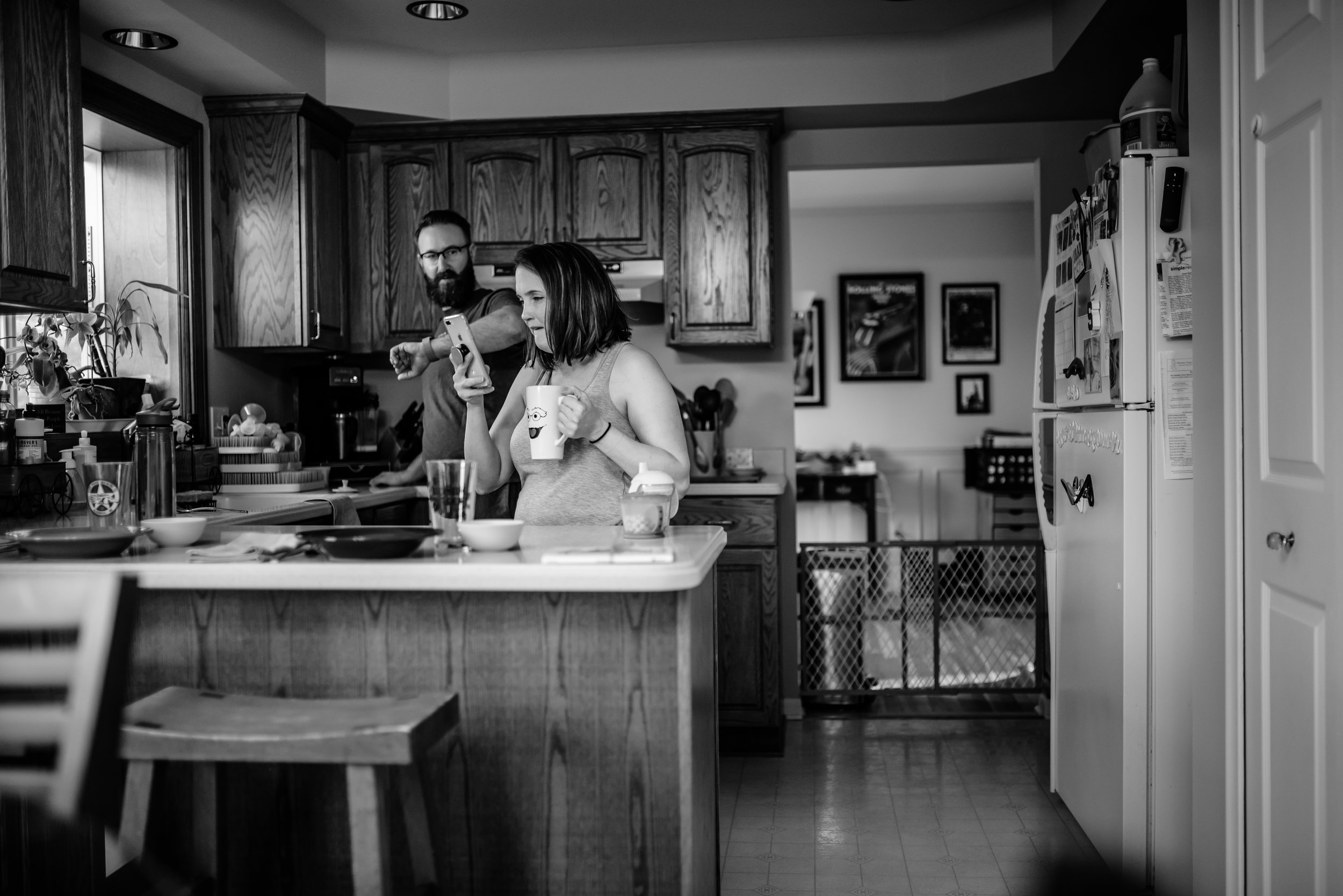 Mom and Dad in kitchen drinking coffee looking at phone and time