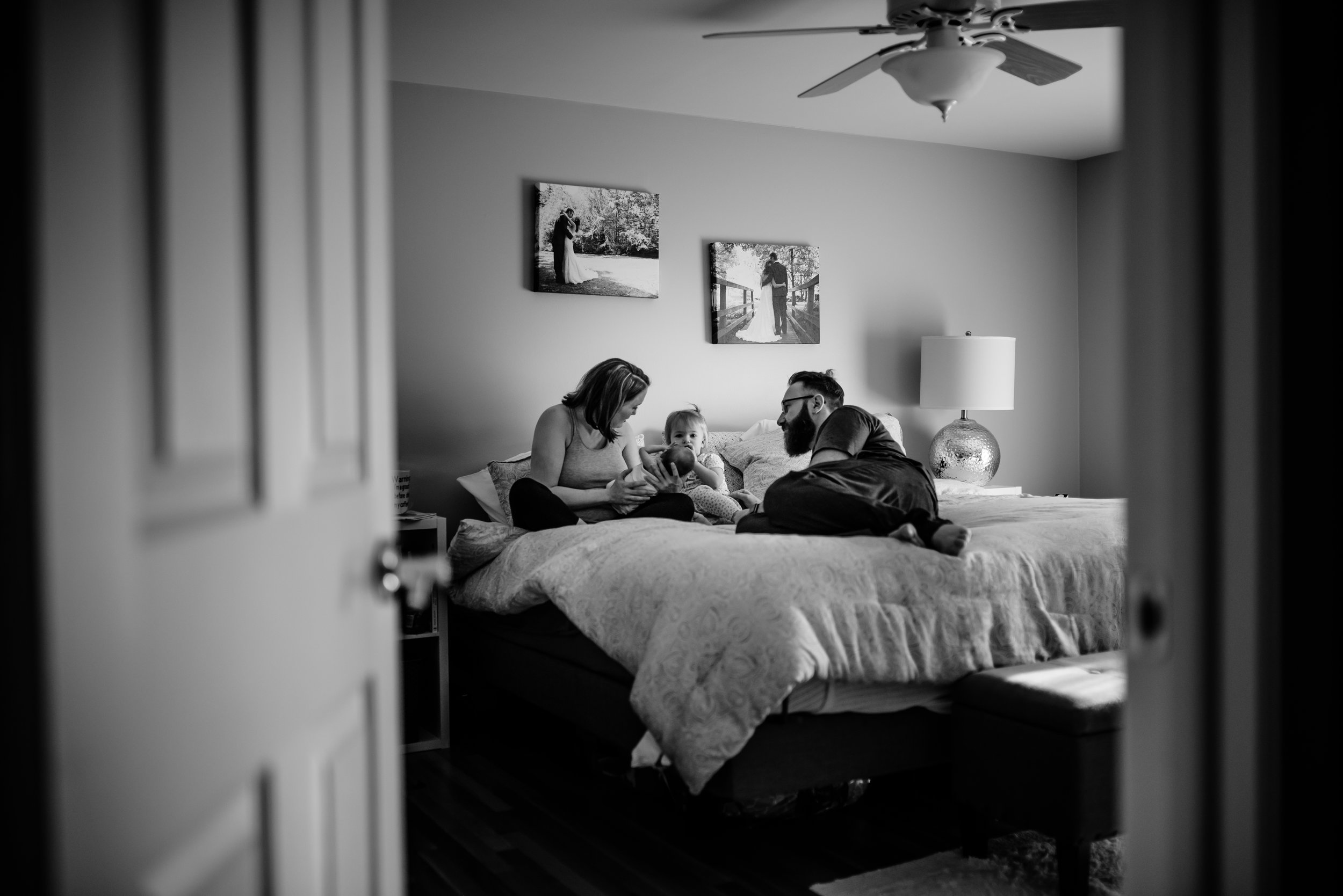 Family hangs out atop bed