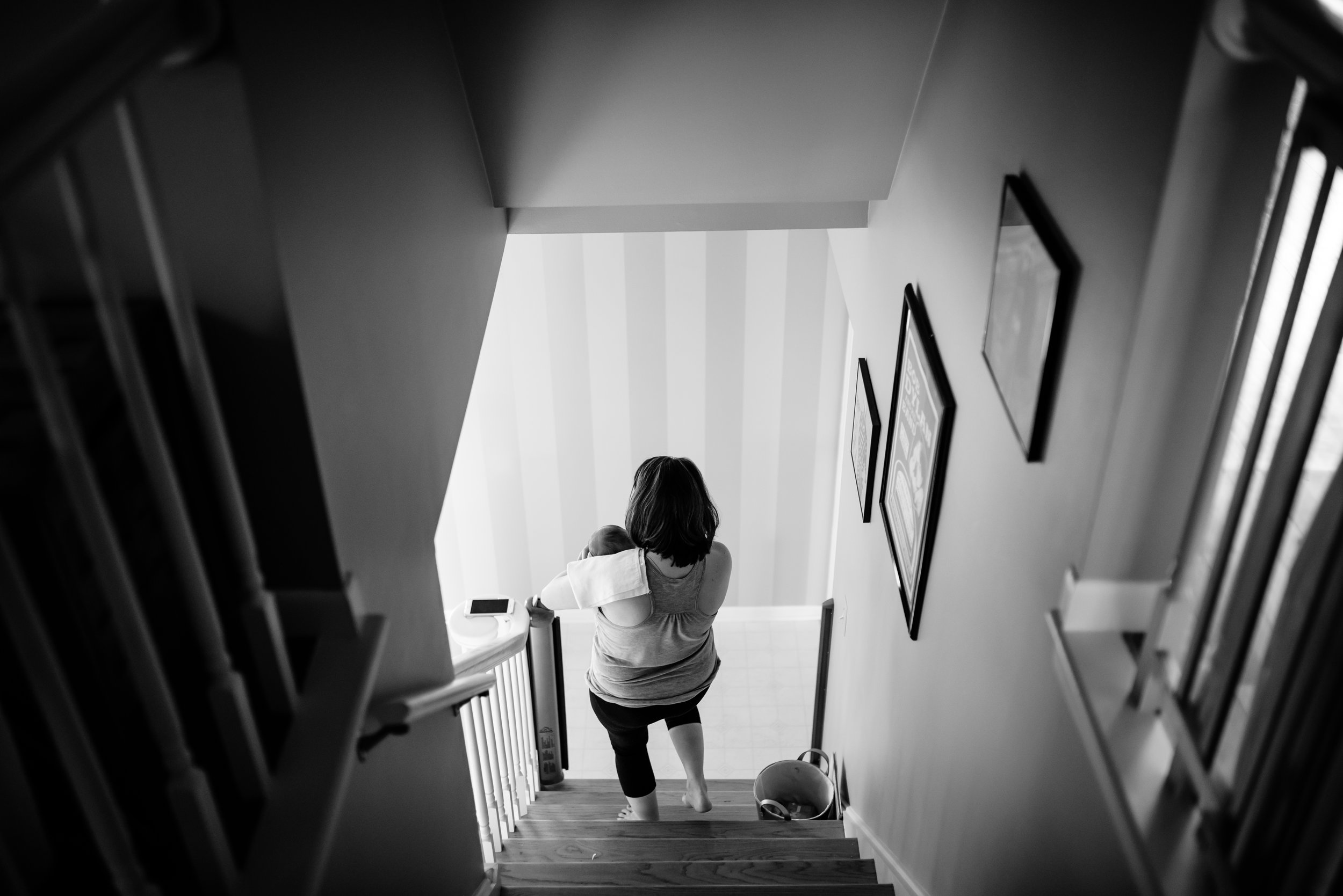 Mom carries baby down stairs