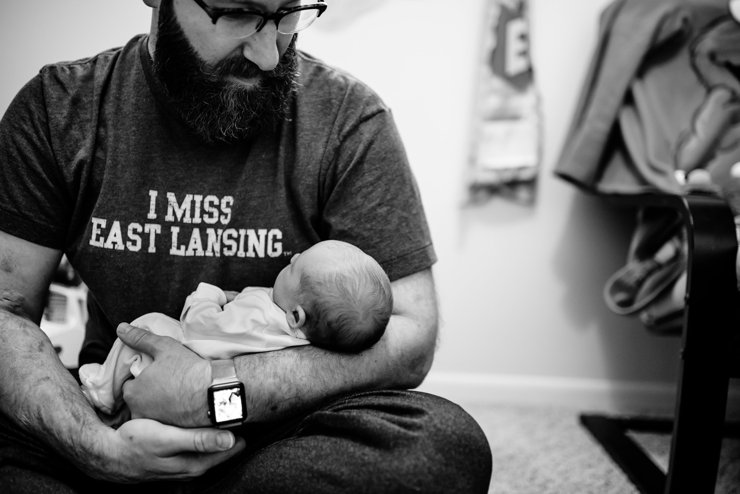 Dad admires baby as he holds her