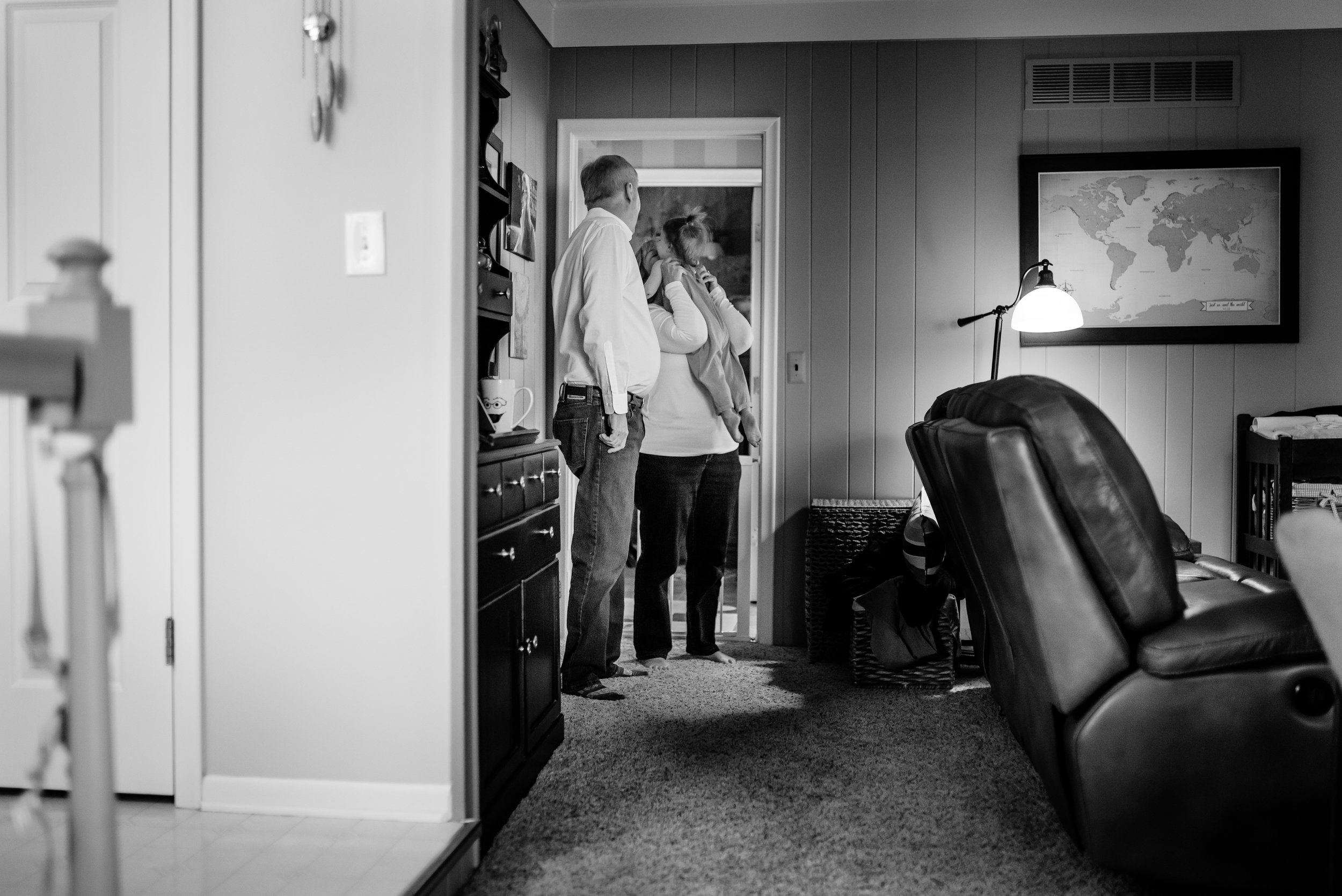 Girl jumps into a hug with her grandmother as her grandfather watches