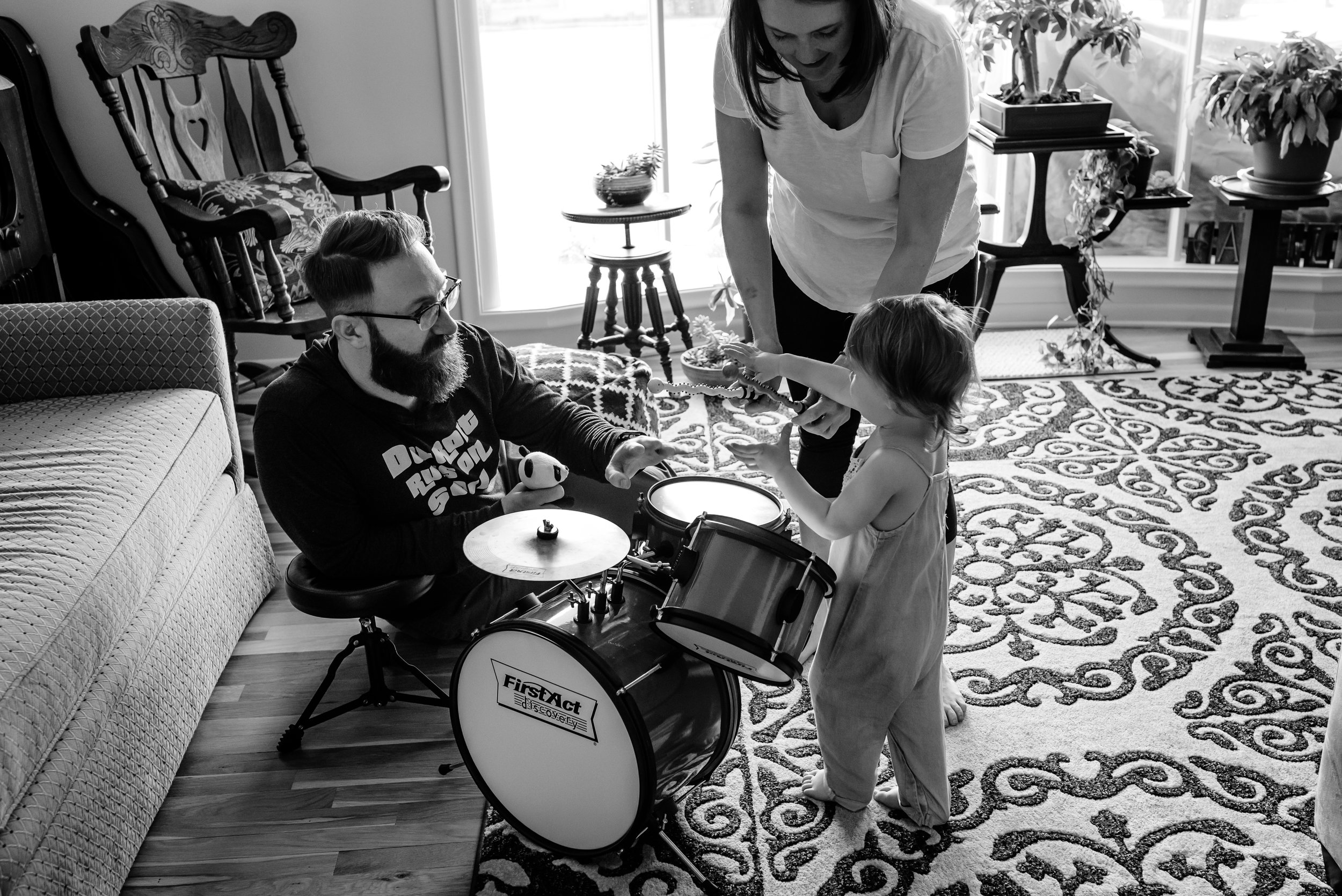 Mom and Dad play drums with daughter