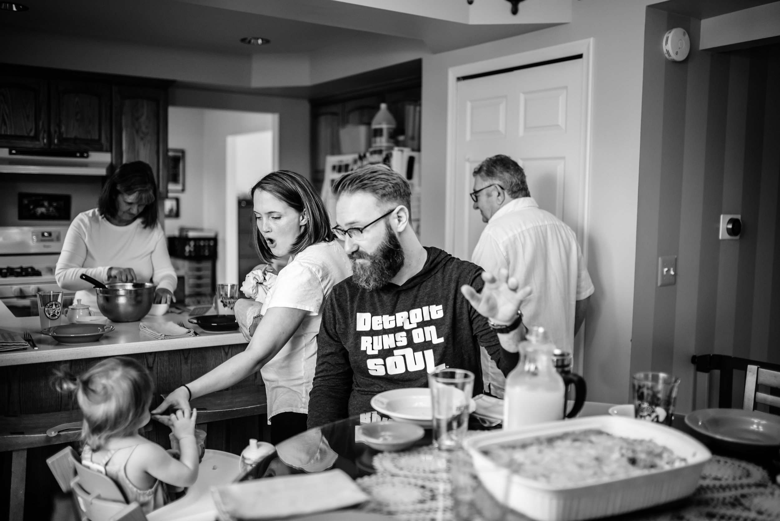 Parents settle into meal and feed toddler