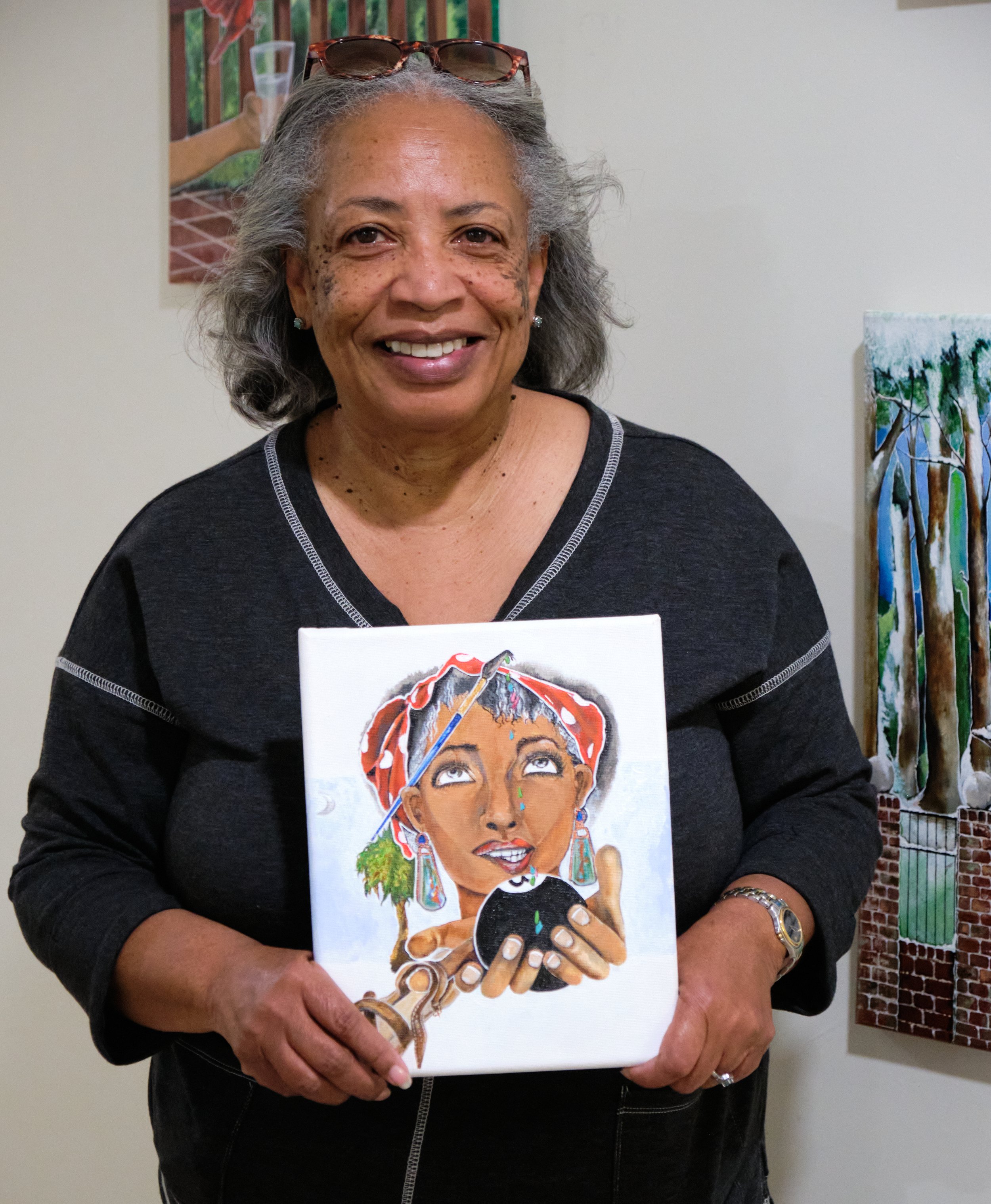 Wilma King posing with her art for the cover of Jasper's fall 2022 issue
