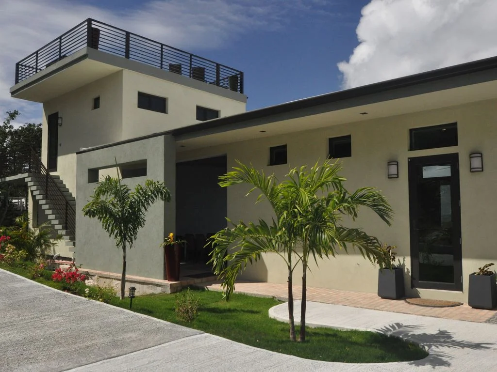 Carney Hawk Hill RoadThis residence atop Hawk Hill has amazing views of the Caribbean sea and distant St. Thomas. The structures is designed to funnel the wind through the gap in the buildings to cool the exterior living spaces
