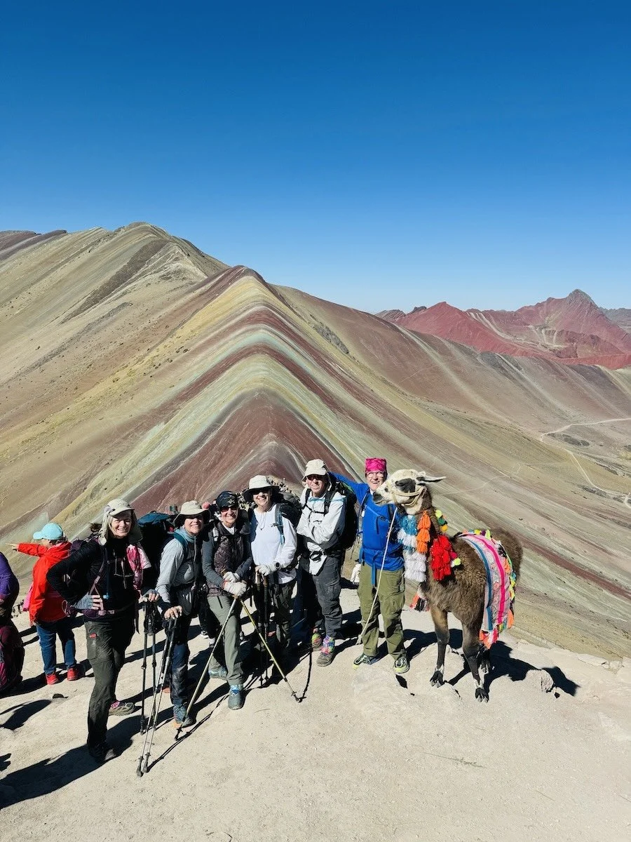 A photo of a guided group trek arrives at Rainbow Mountain, near Cusco, Peru