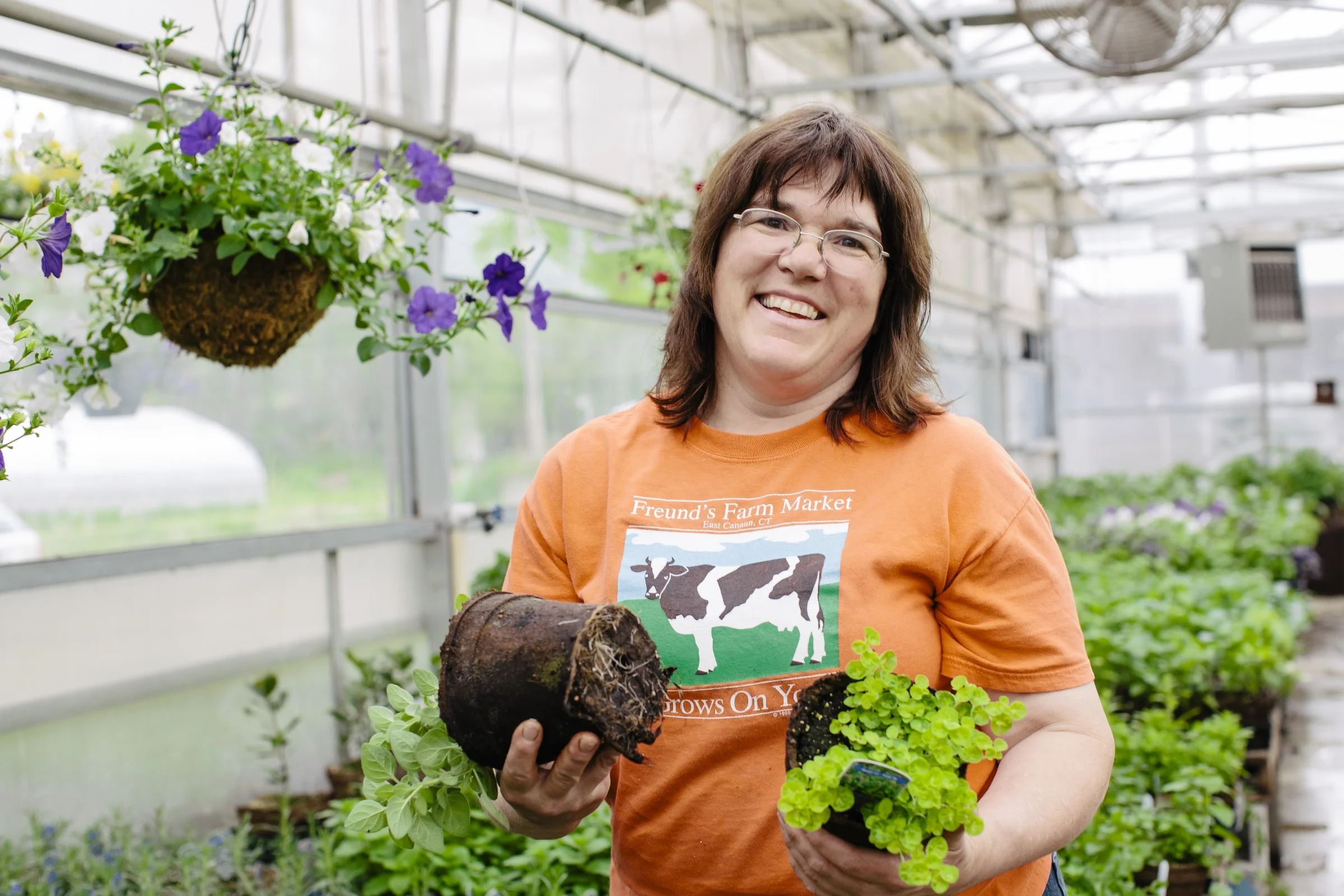 photo credit: Cabot Creamery Theresa Freund, owner of Freund's Farm Market shows off homegrown herbs growing in CowPots.