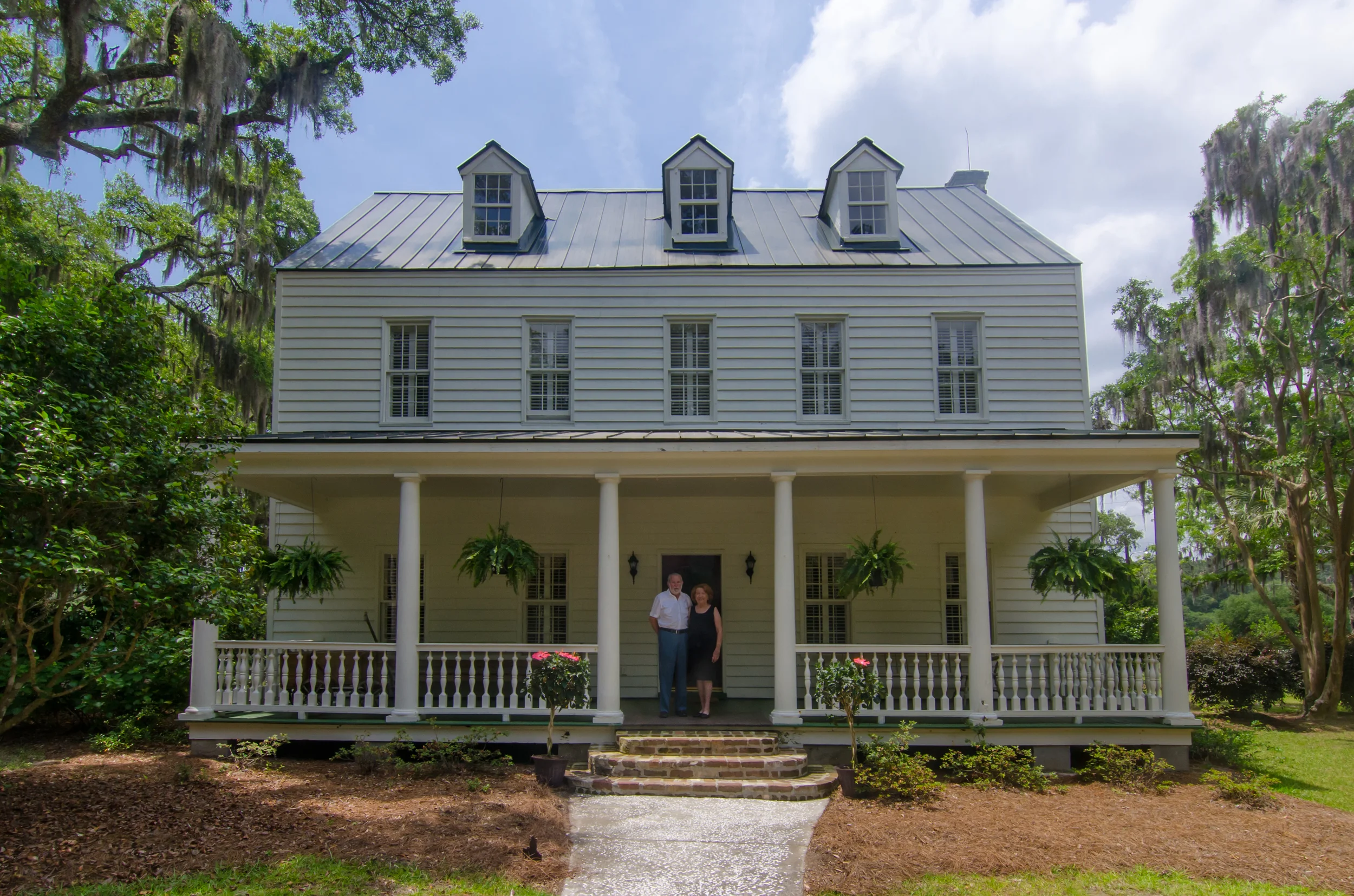 Ralph and Brenda Morris in front of their home, the Bailey Plantation House.